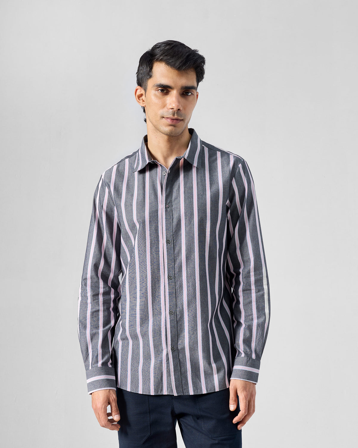 Person wearing a charcoal and pink striped Classic shirt with horizontal cuffs.