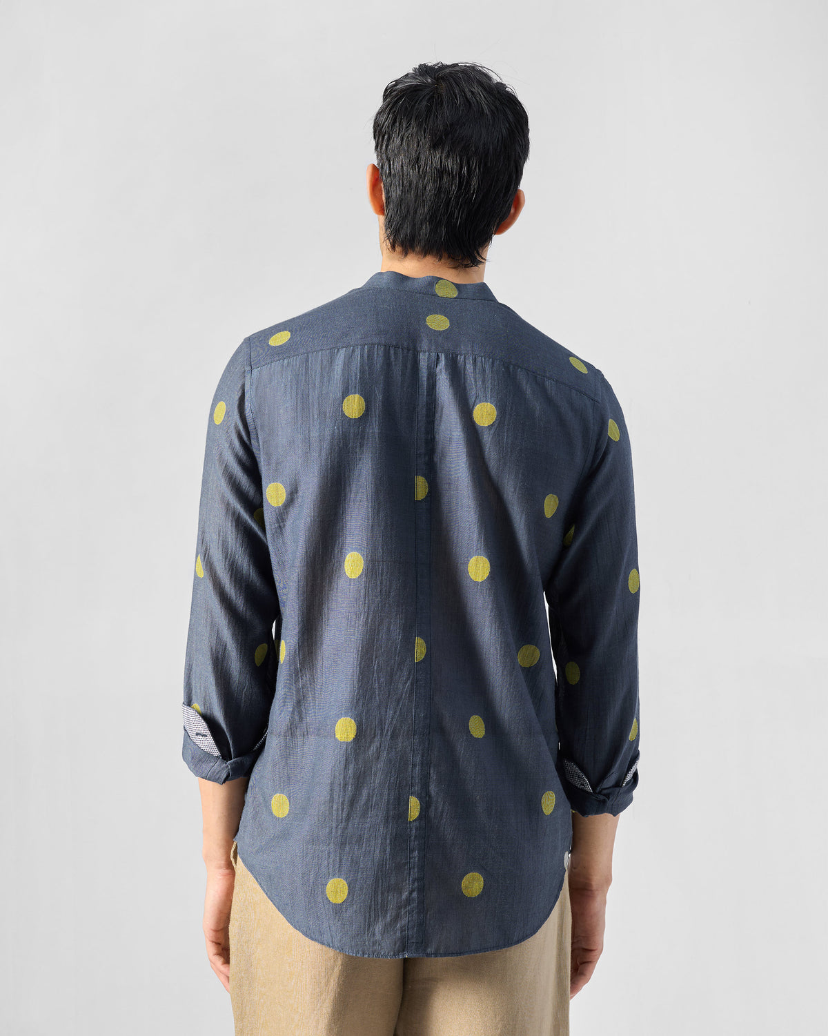 Back of a charcoal Nawab Shirt with chartreuse jamdani polka dots.