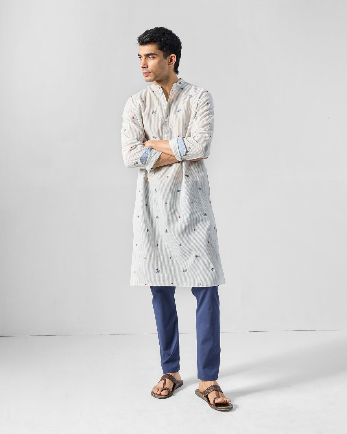 Person wearing a charcoal and white Bageecha kurta with animal embroidery.