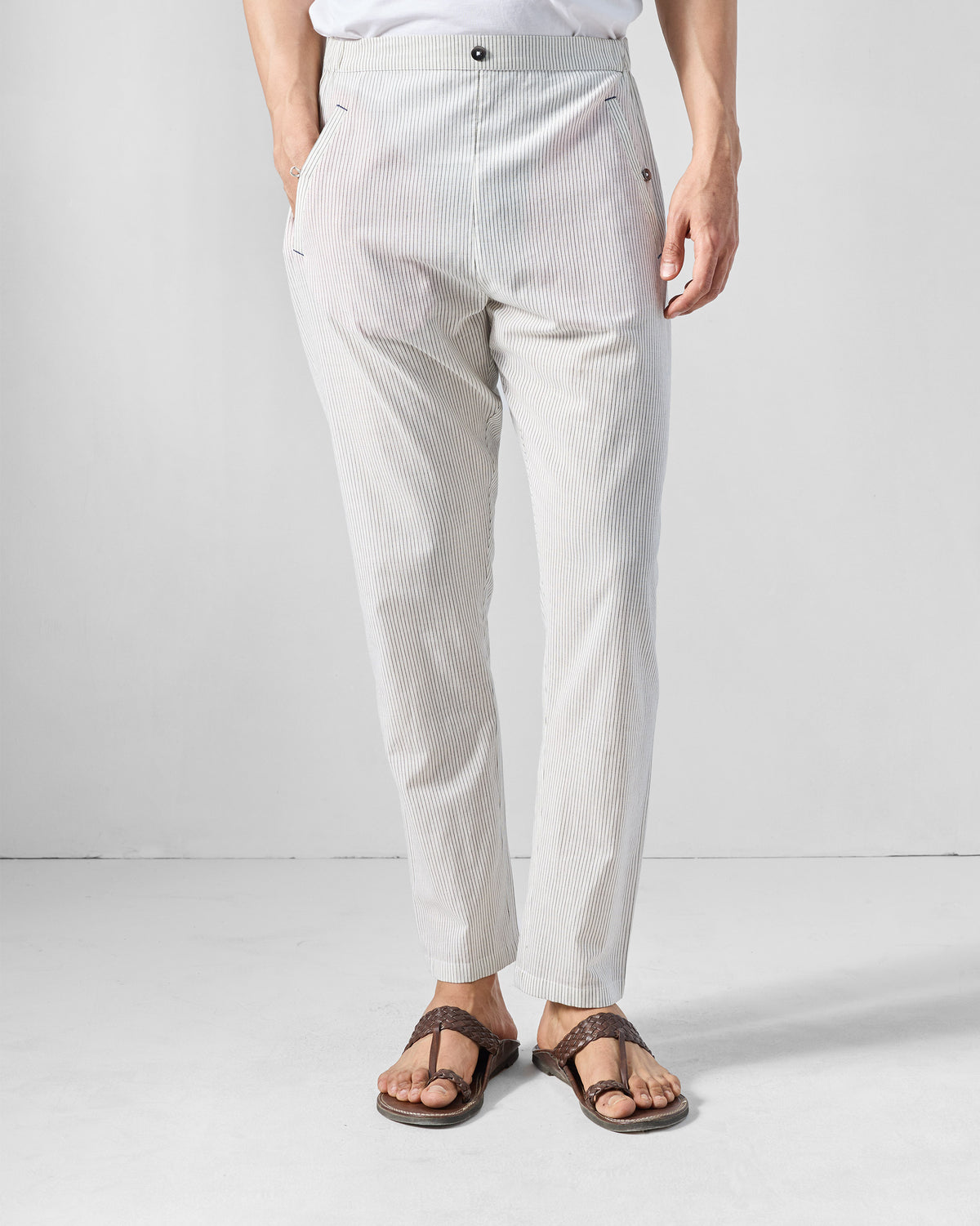 Person wearing charcoal and white striped Kurta Pants with a flat front.