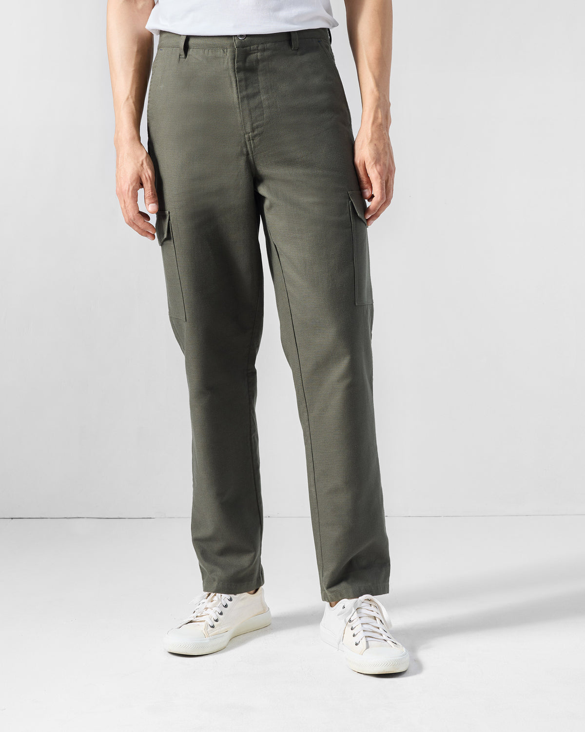 Olive Riverbank pants with side cargo pockets, worn front-on.