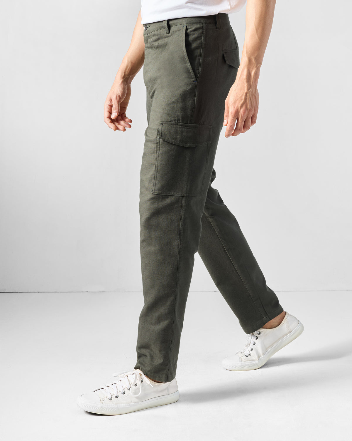 Side view of olive Riverbank pants showing a flap cargo pocket.