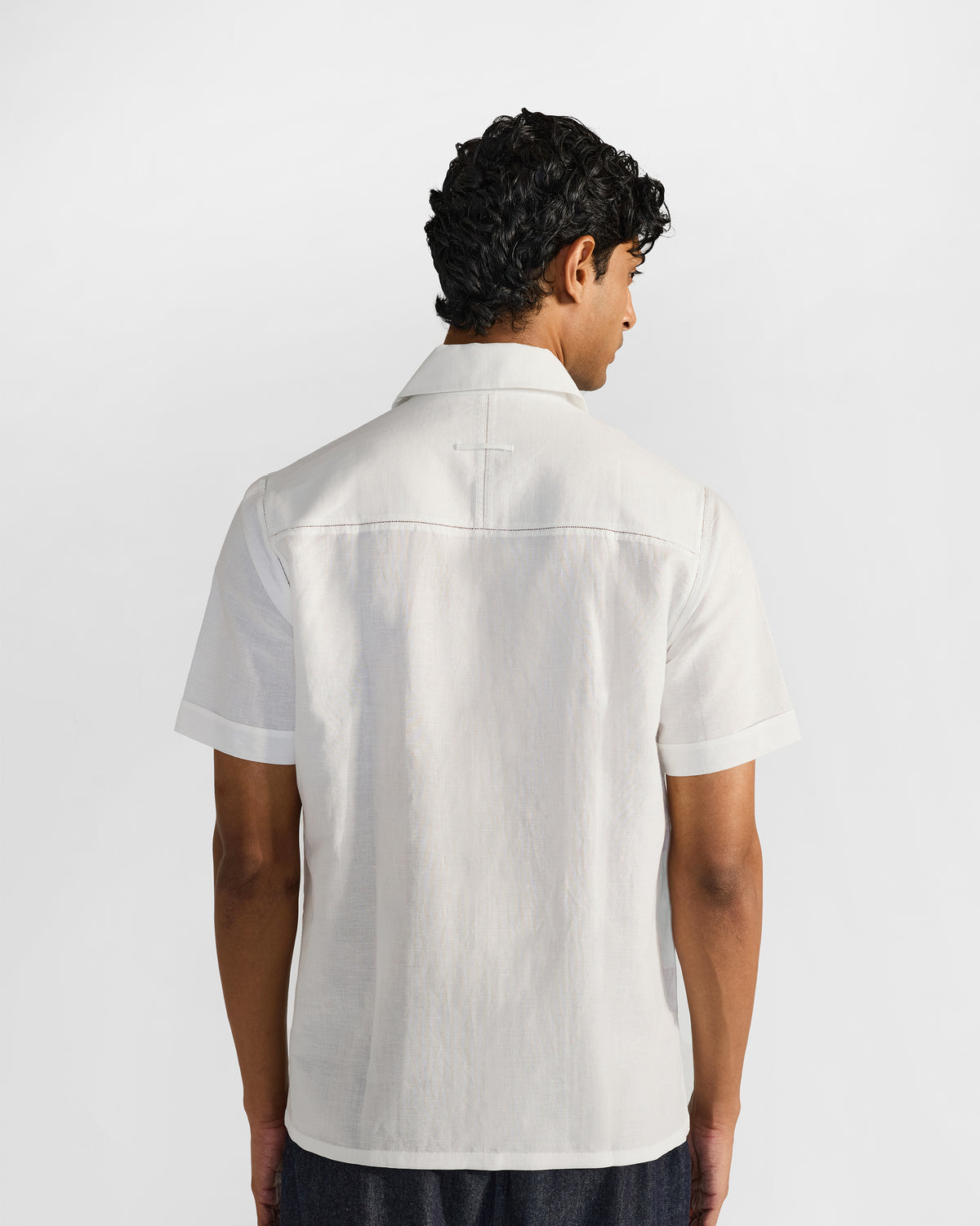 Back of a white Egret shirt showing the yoke seam.