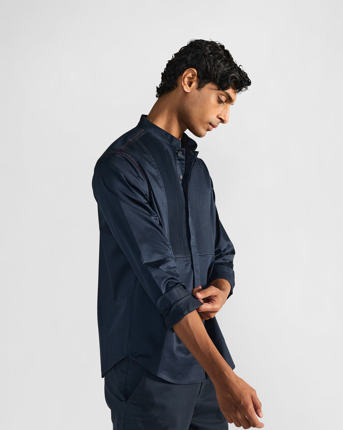 Side view of a navy Nightjar shirt worn by a person.
