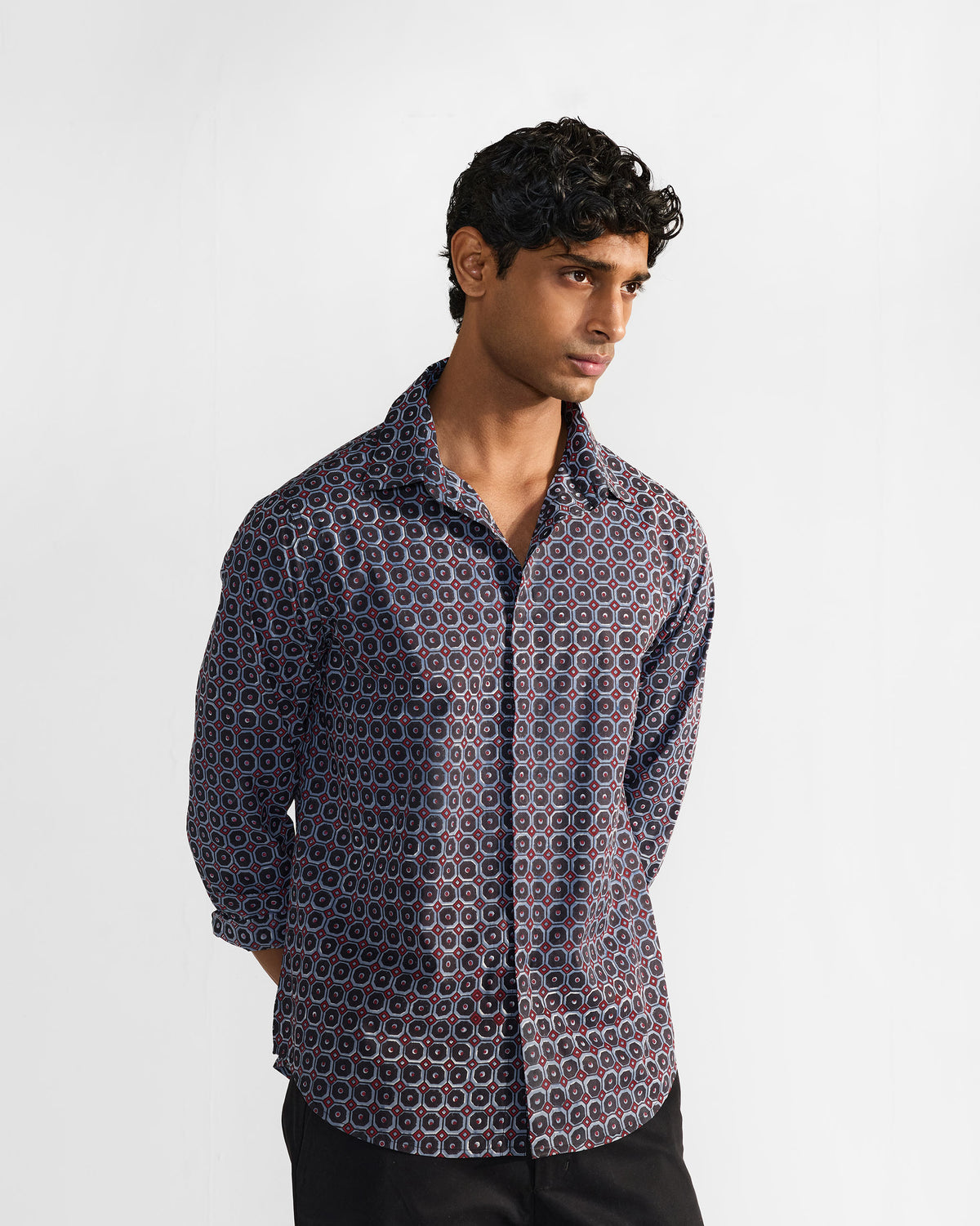 Wood Pigeon Shirt with sleeves pushed up in a navy geometric print.