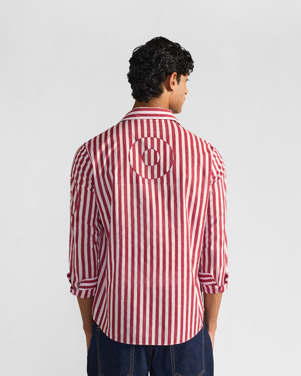 Back of a red and white striped Civet shirt with a circular stripe motif.