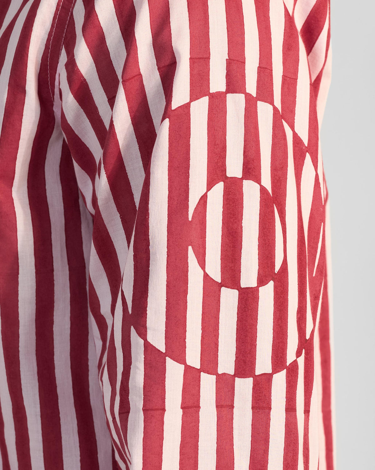 Close-up of the circular print on a red and white striped Civet shirt.
