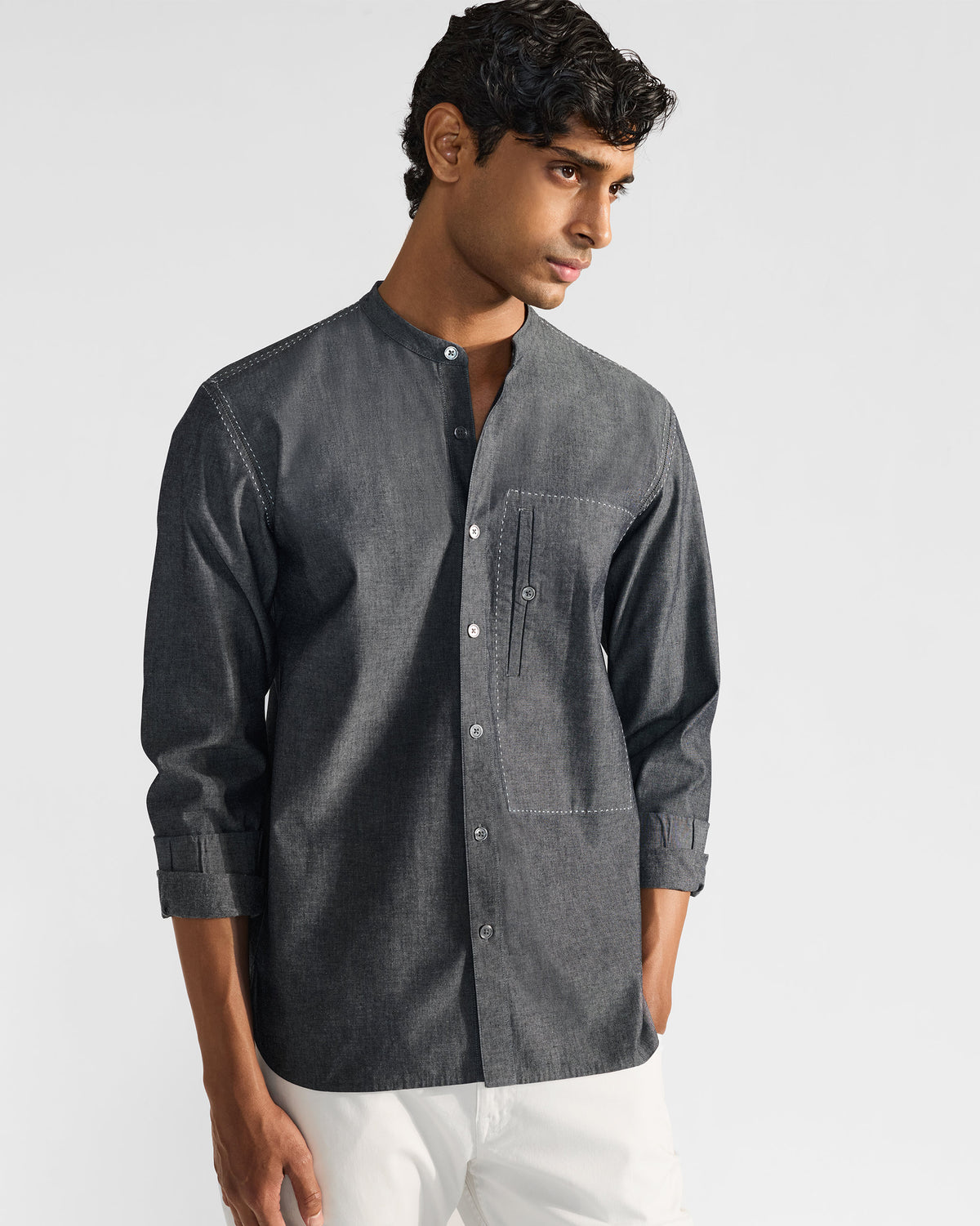 Person wearing a charcoal Marten shirt with a framed chest pocket.