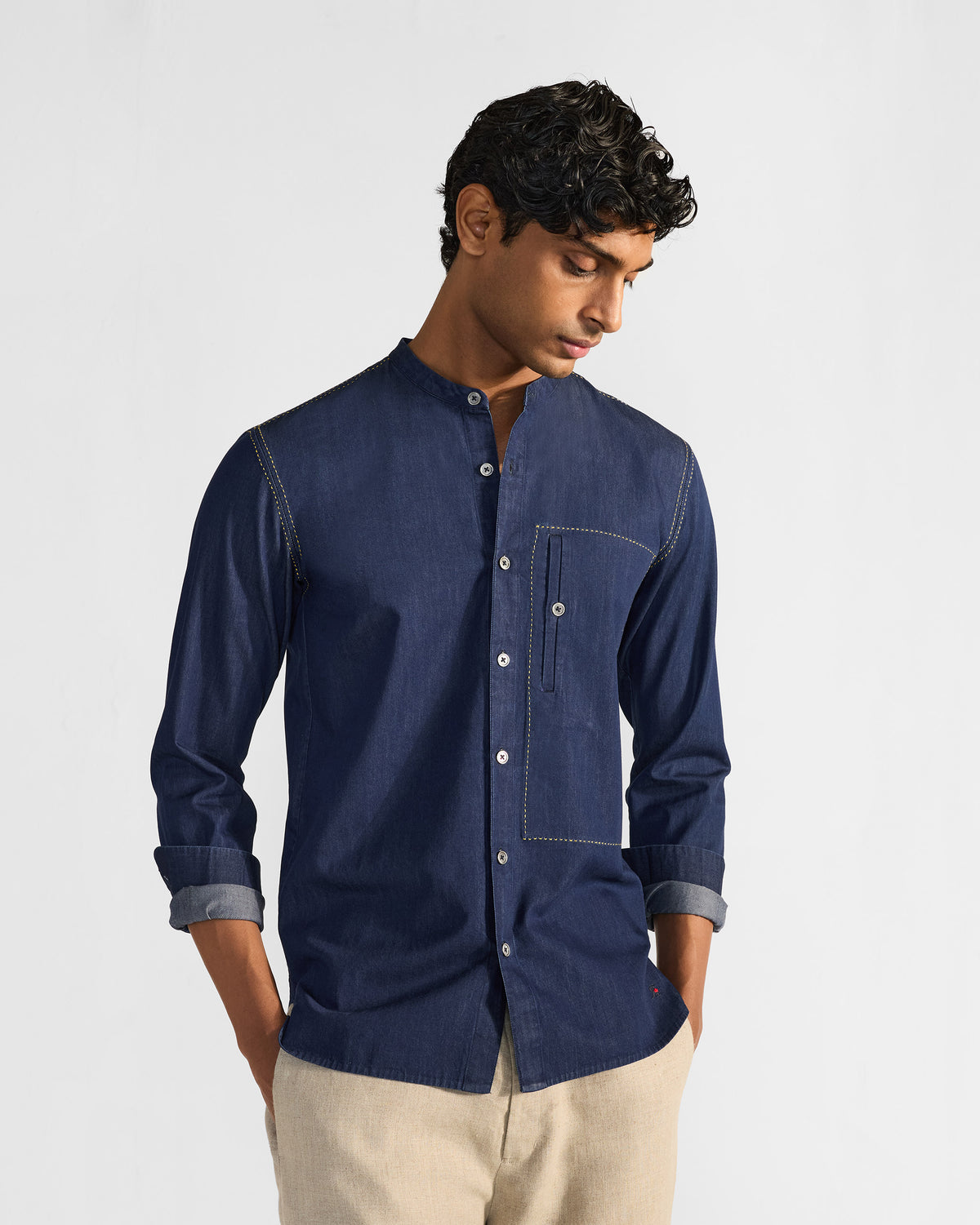 Person wearing an indigo Loris shirt with a chest pocket.