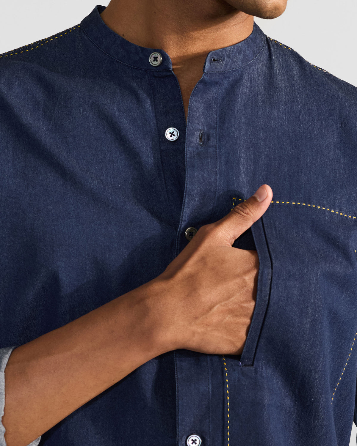 Close-up of an indigo Loris shirt collar and chest pocket.