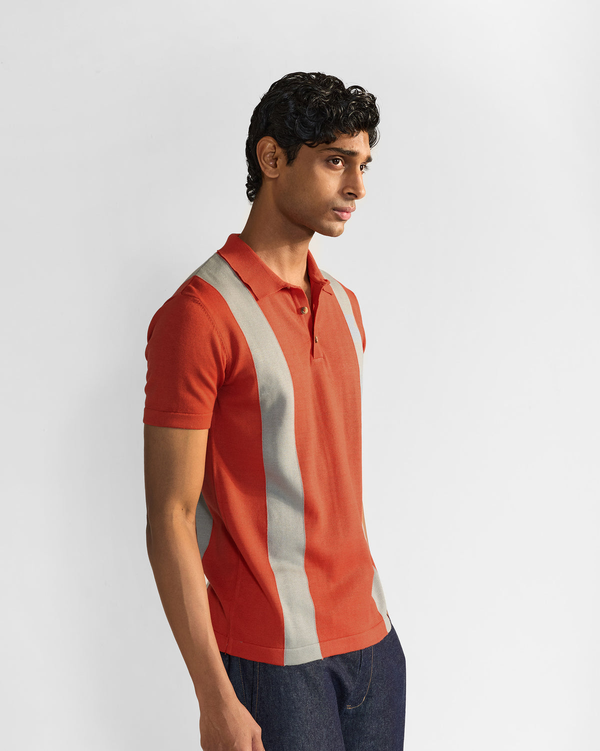 Bonnet Polo side three-quarter in rust orange with grey stripes.