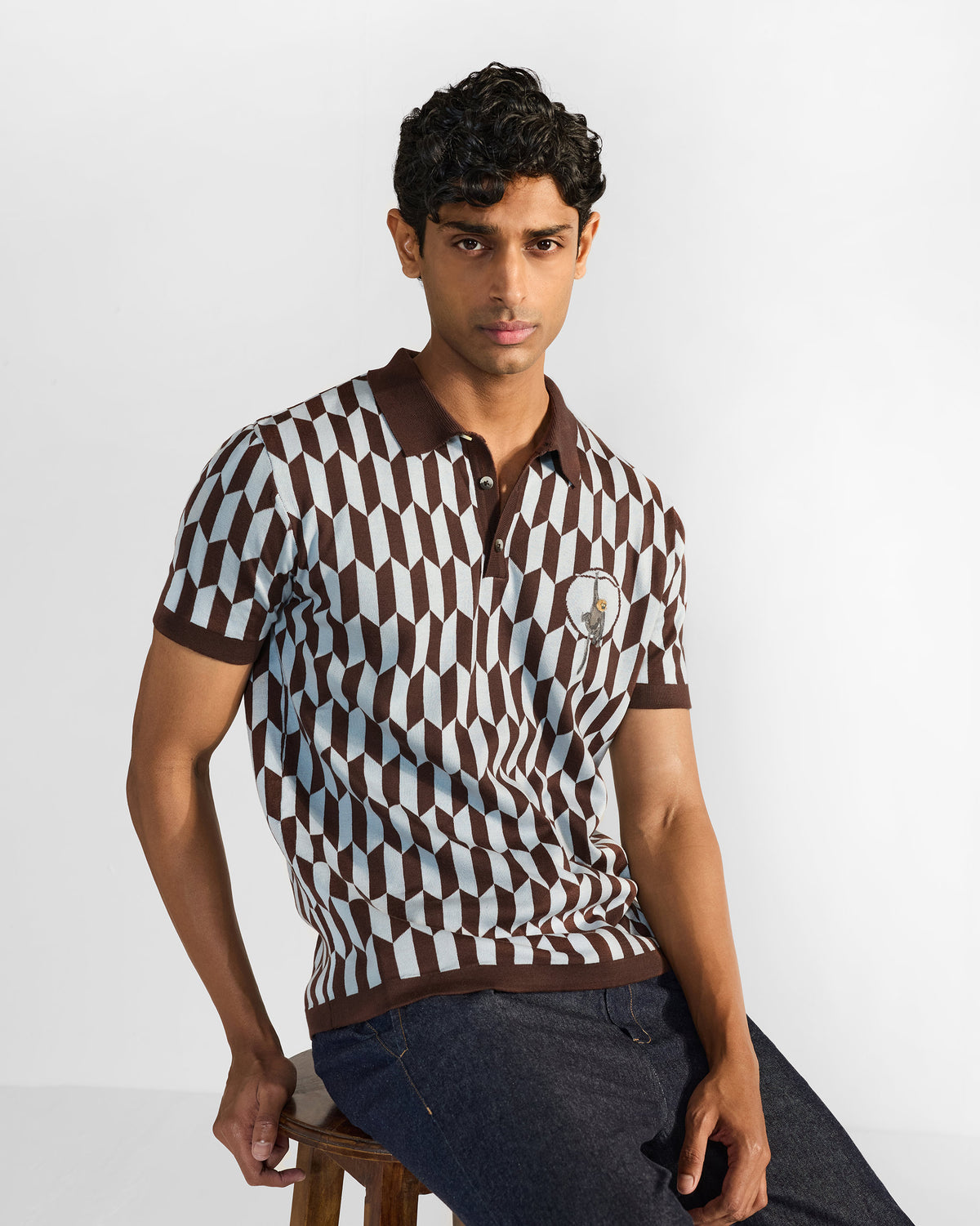 Person wearing a brown and light grey geometric Langur polo with a brown collar.
