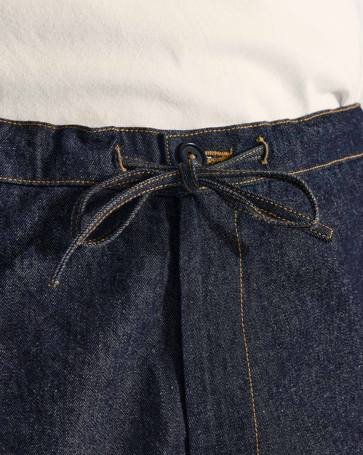 Close-up of the denim drawstring waist on Thrush Trousers.