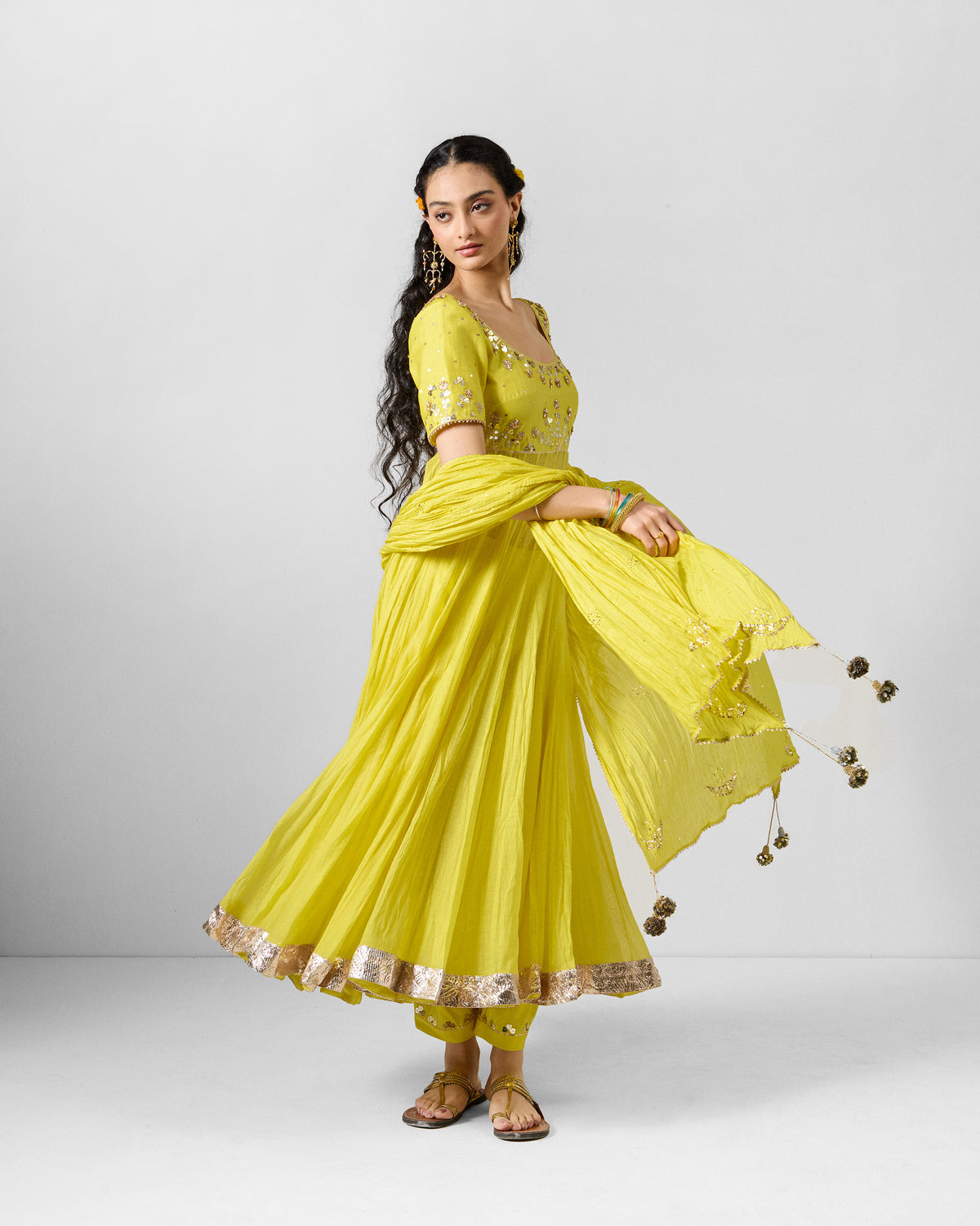 Yellow embroidered Shanti dupatta draped over a matching yellow outfit.