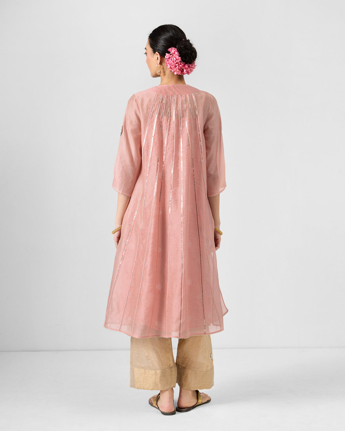 Back of a pink embroidered Sukhna kurta with slip showing vertical silver sequin stripes.