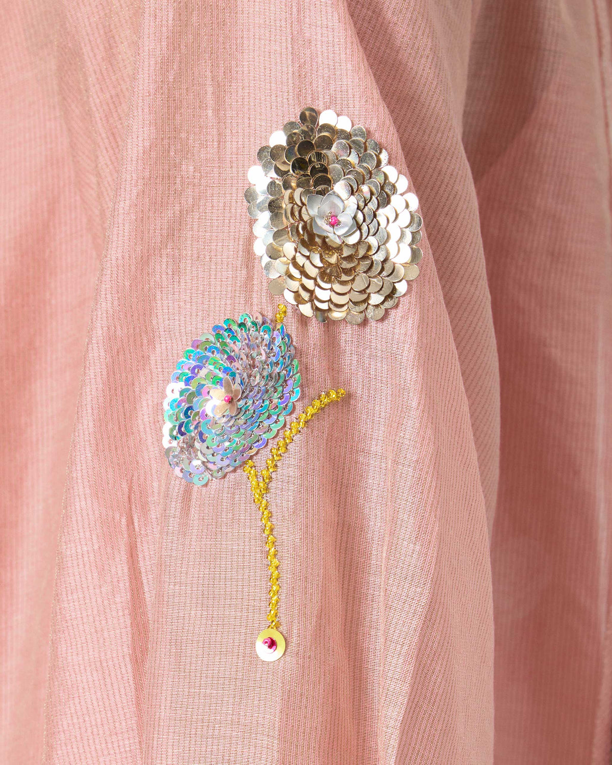 Close-up of sequin flower embroidery on a pink embroidered Sukhna kurta with slip.