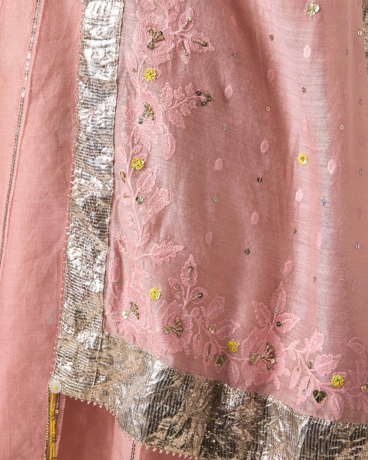 Close-up of dust pink Lila dupatta fabric with floral embroidery and silver gota.