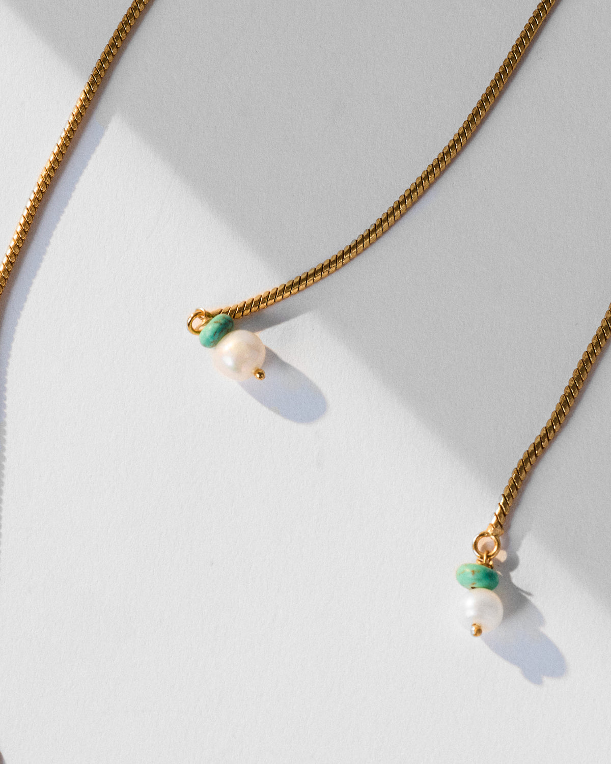 Gold Milni necklace clasp and chain-end detail.