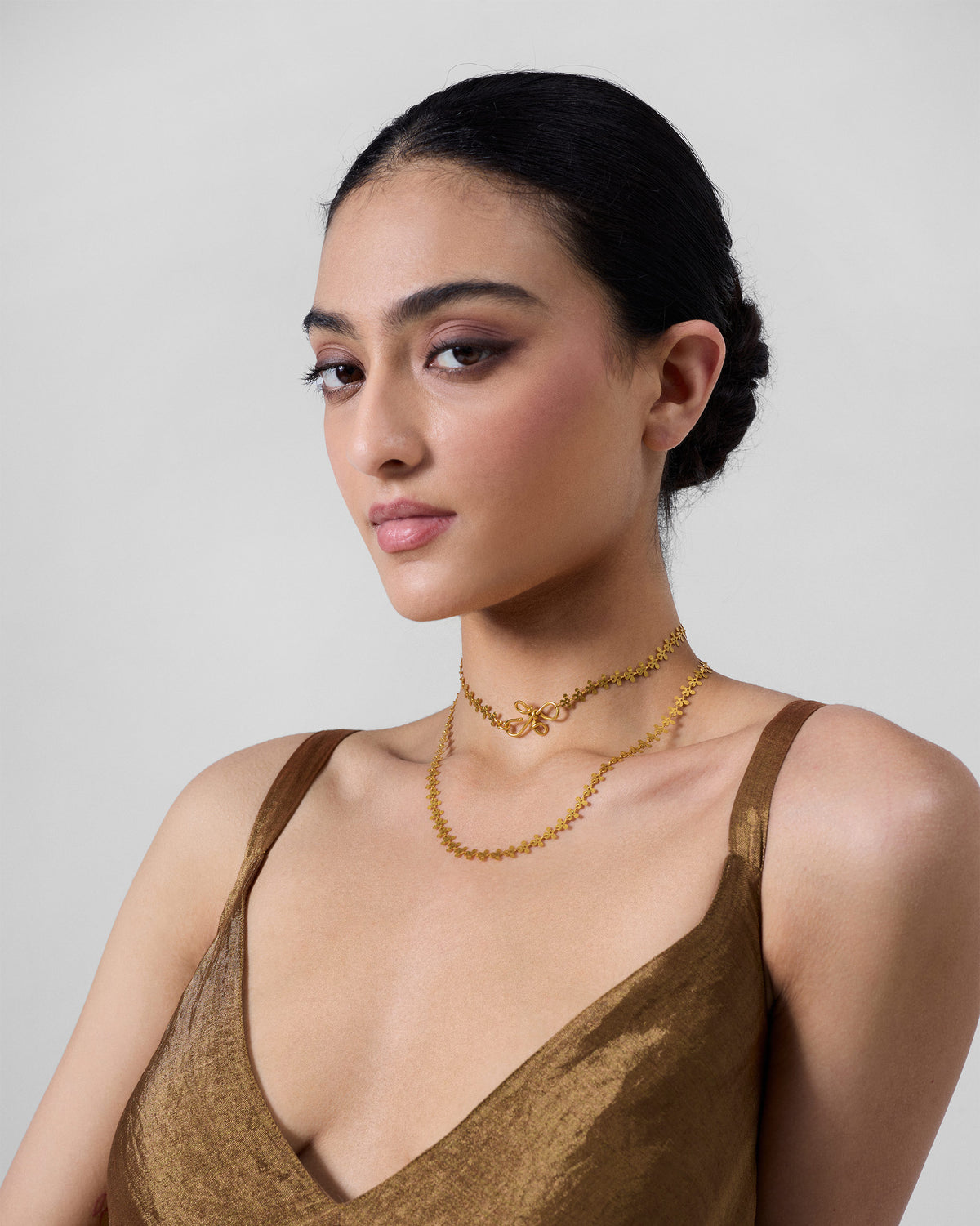 Gold Milni necklace worn as a choker and a longer layer.