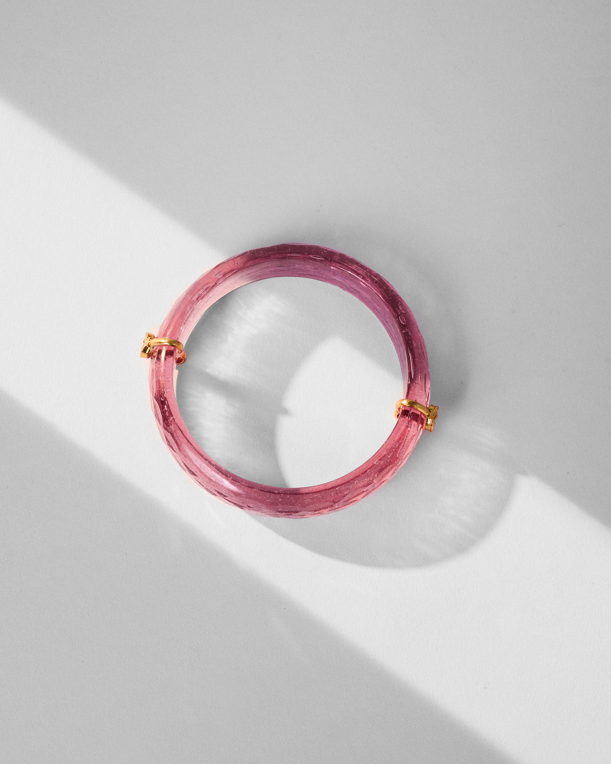 Overhead view of a Shaan Bangle laid flat, showing its gold accents.