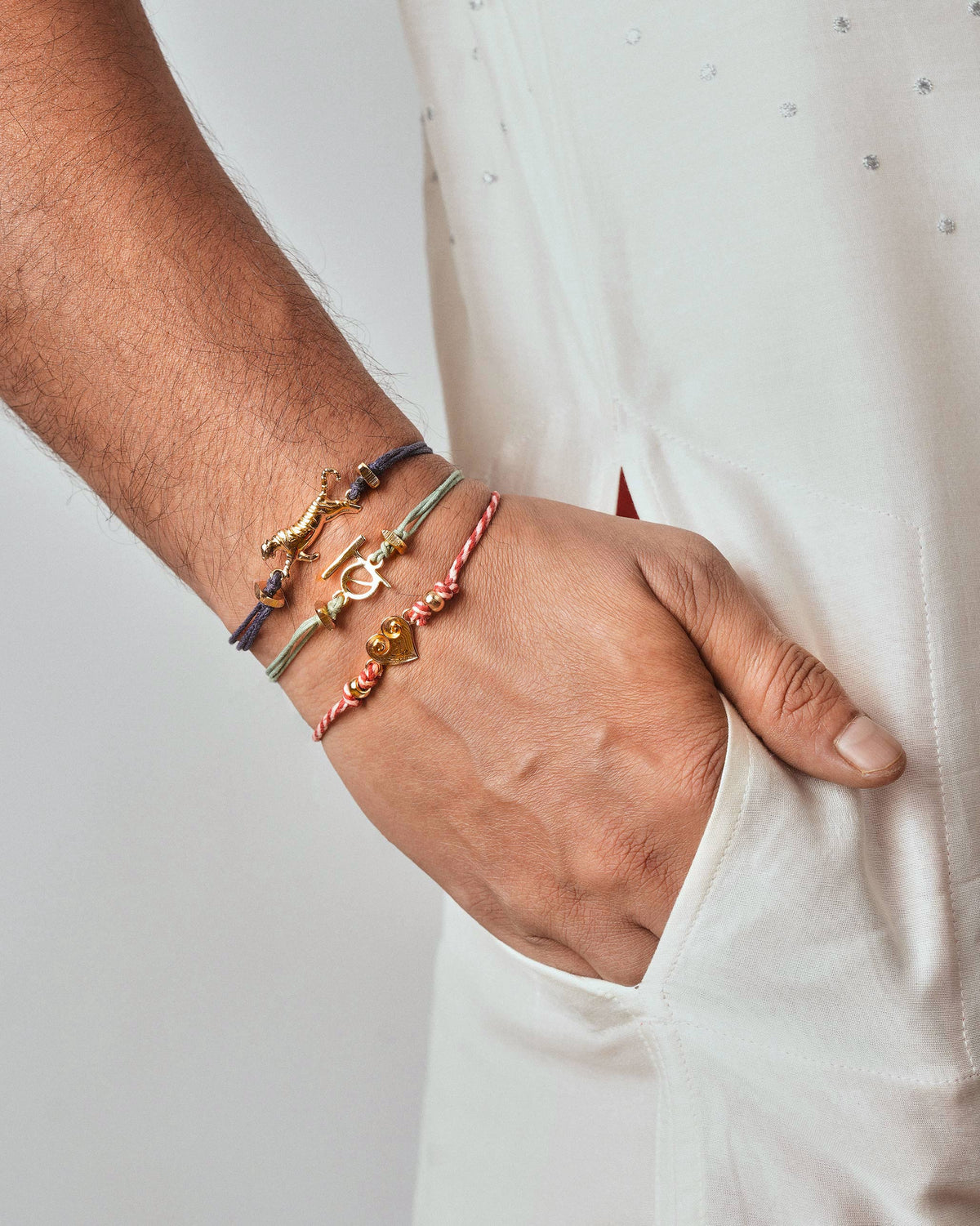Person wearing a Dil Rakhi in red and white stripes on the wrist.