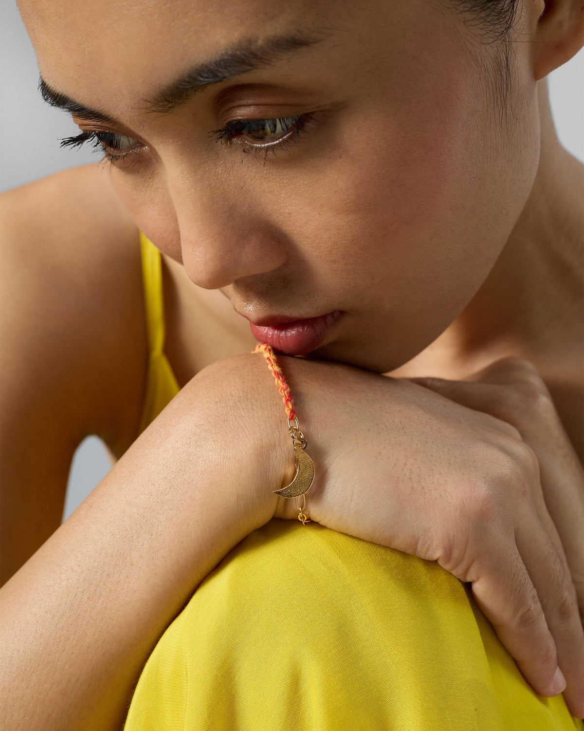Person wearing Crescent Charmlet on the wrist, with the crescent charm visible.