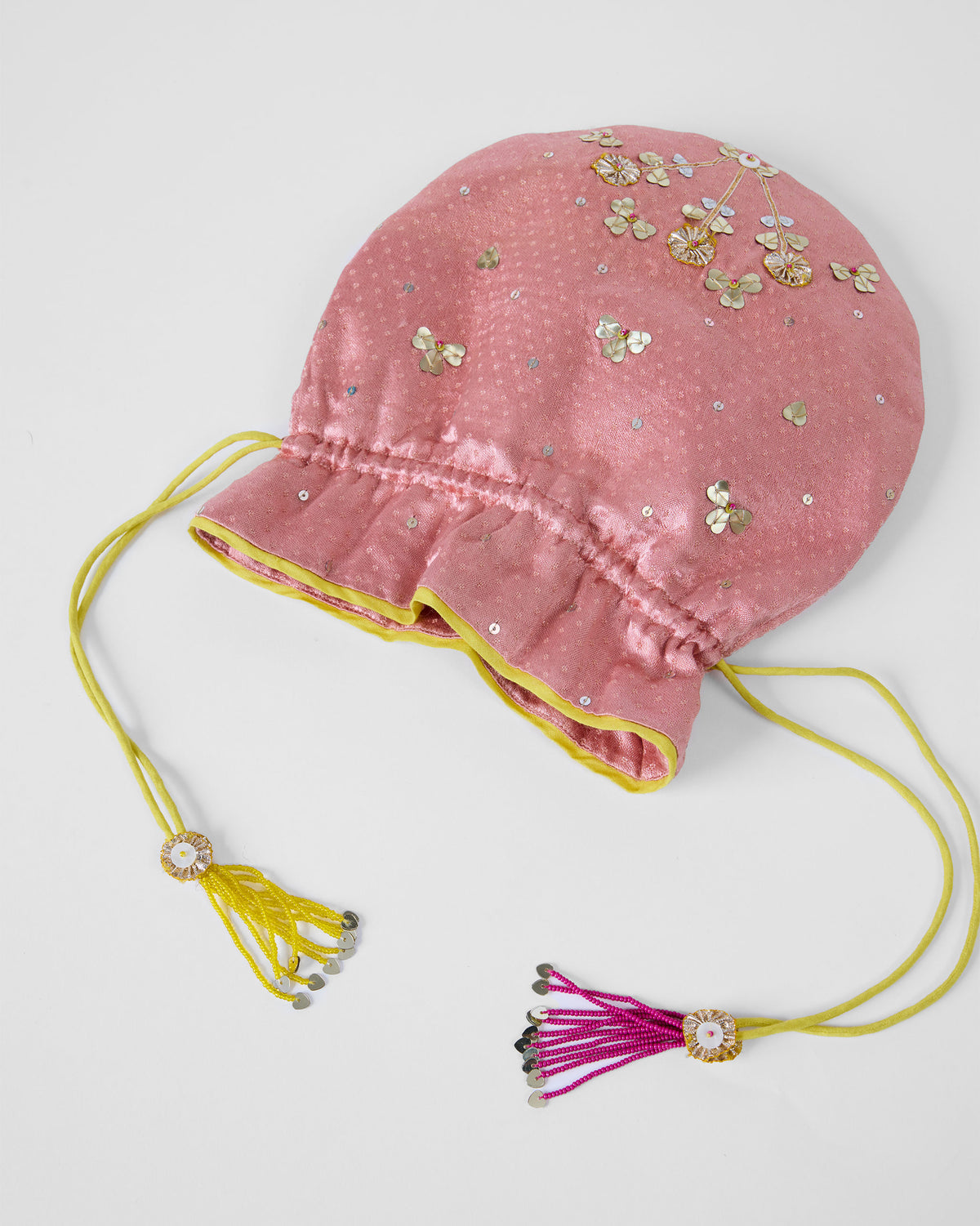 Light pink Meher potli with green and magenta drawstring tassels.