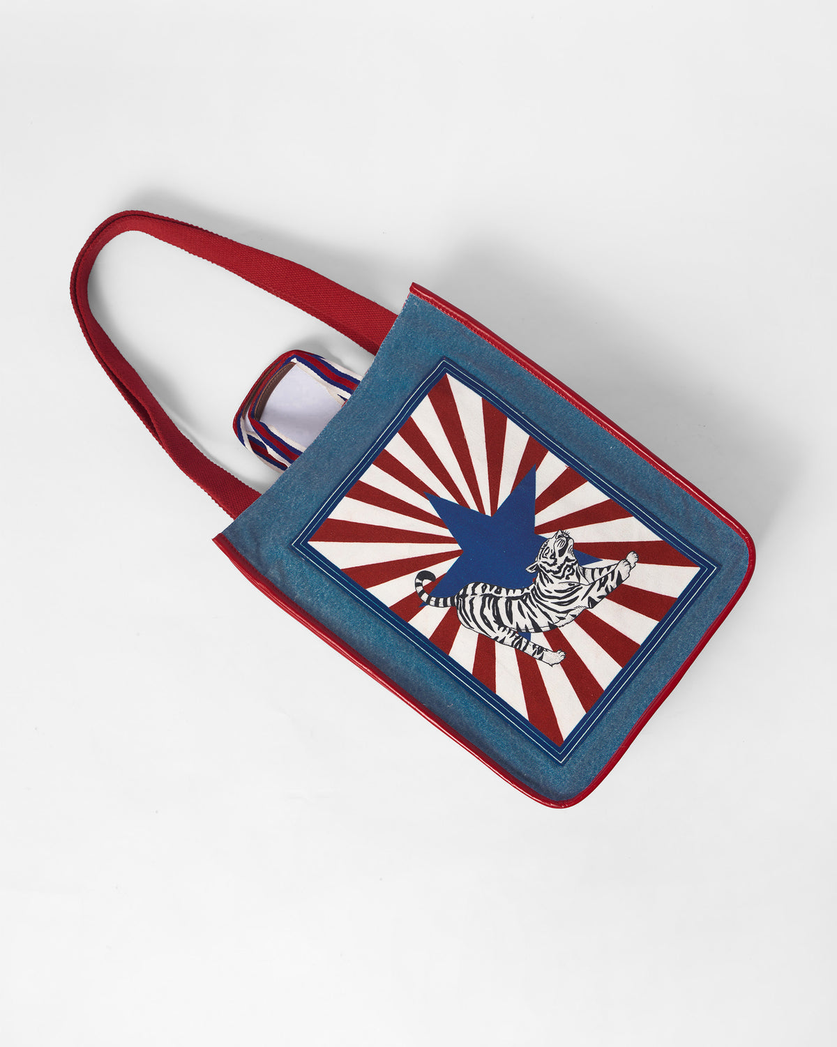 Blue Nico Matchbox tote with a tiger and star print.