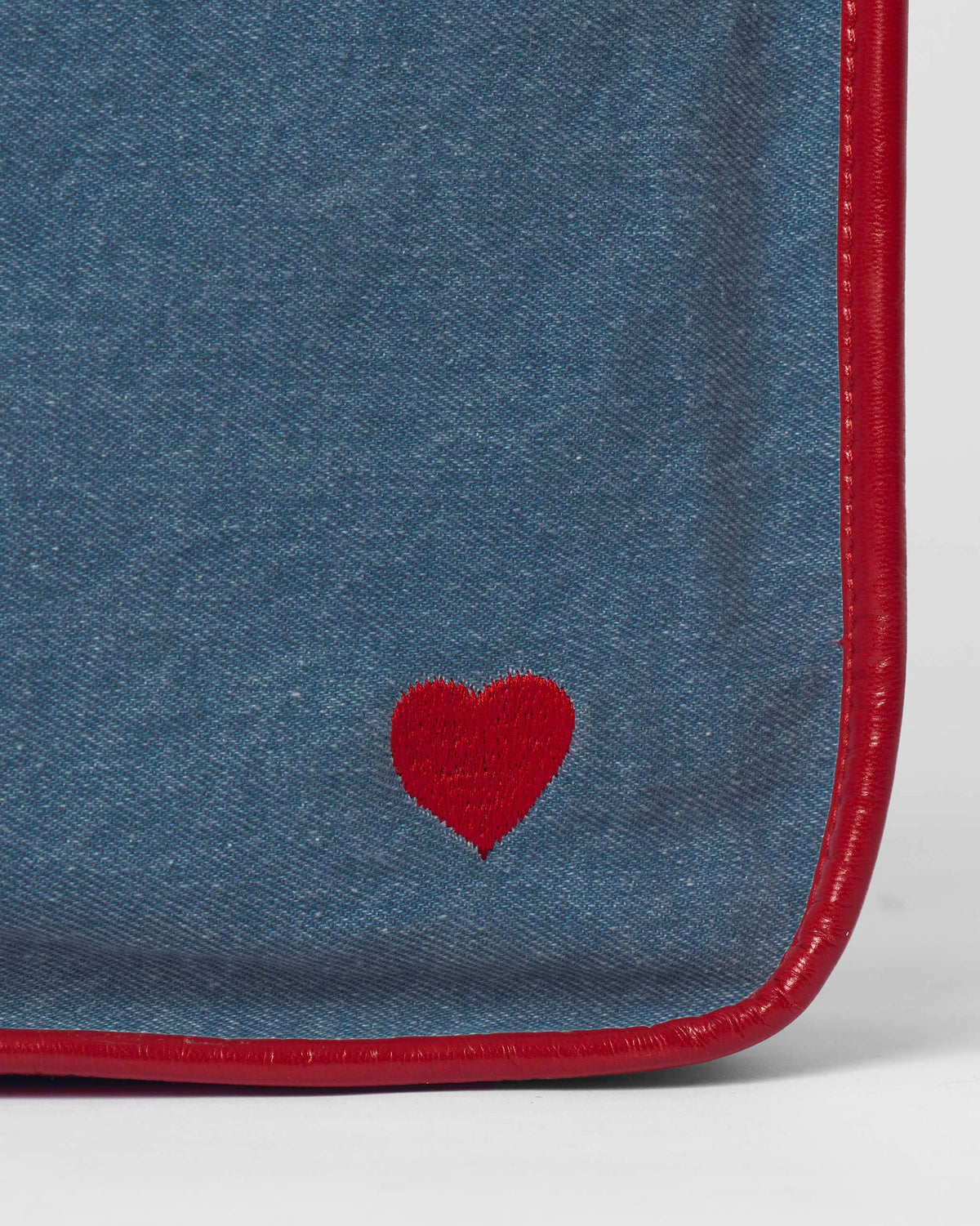 Close-up of a Nico Matchbox tote showing a red embroidered heart.