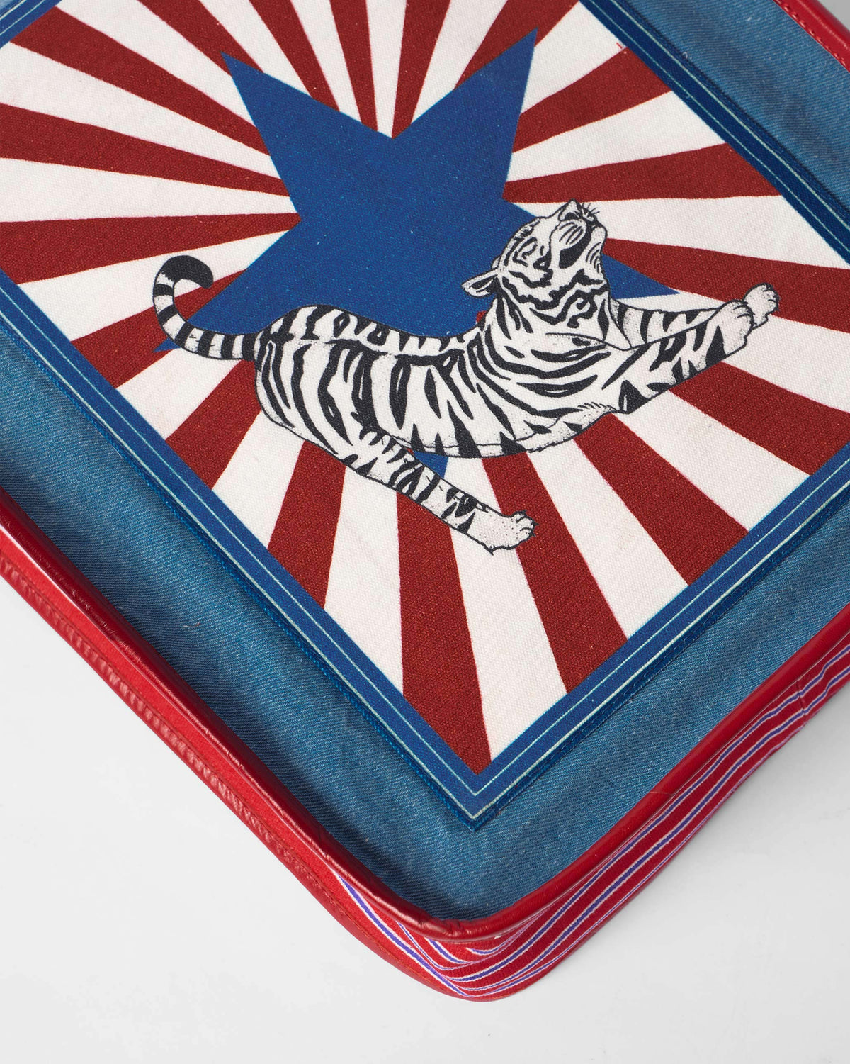 Close-up of a Nico Matchbox tote showing the tiger stamp graphic.