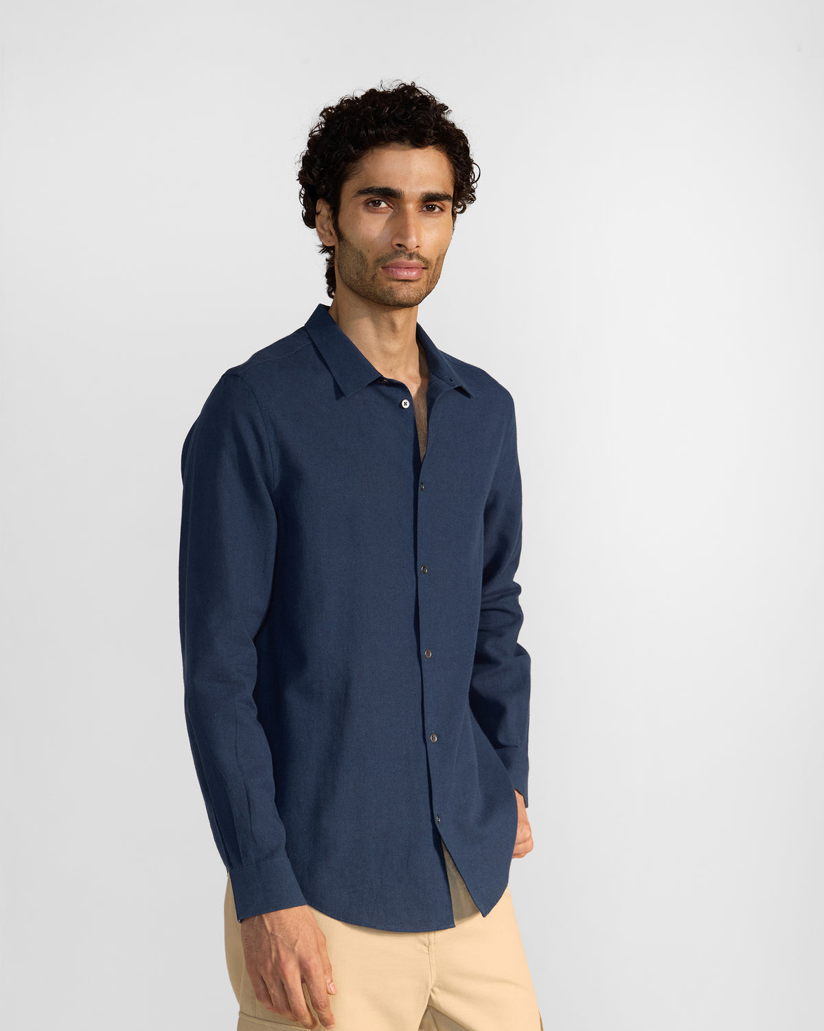 Person wearing a navy Rewa shirt at a three-quarter angle.