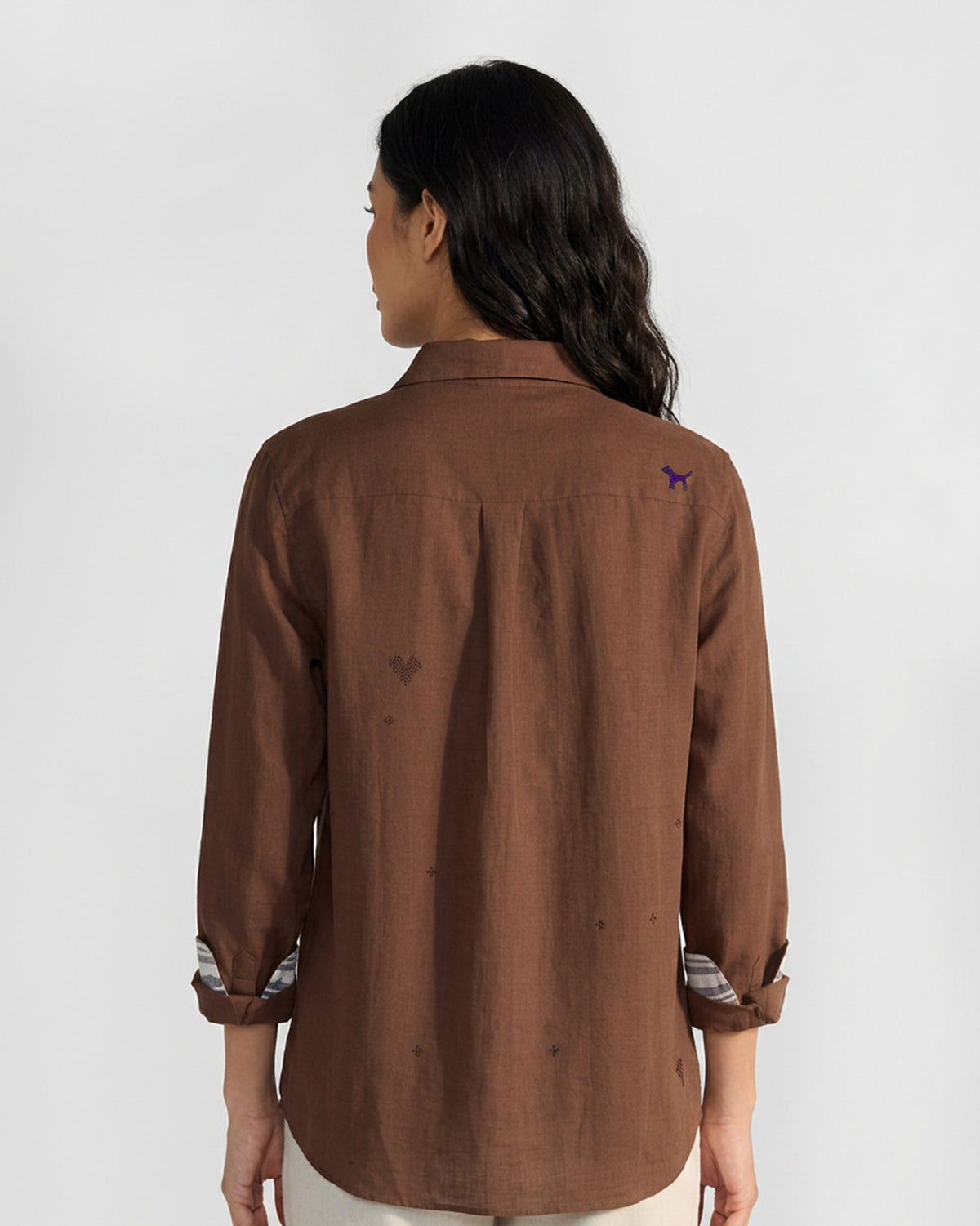 Back of a brown Classic Shirt with purple dog embroidery on the shoulder.