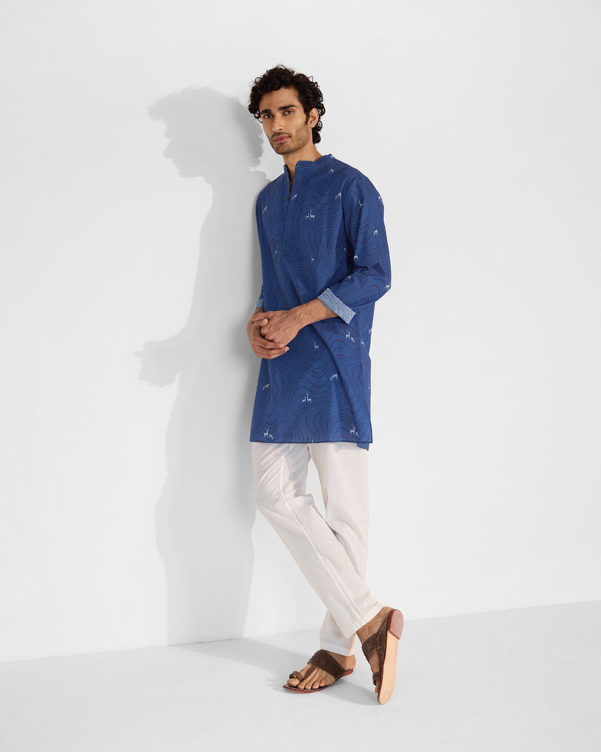 Person wearing a blue Front Pleat kurta with all-over deer print.