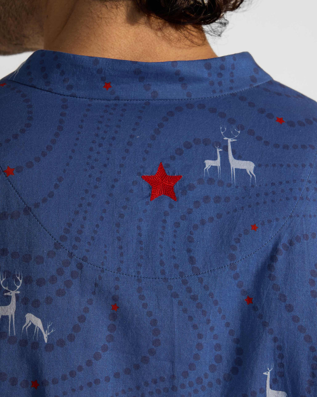 Close-up of a red star and deer print on the back of a blue Front Pleat kurta.