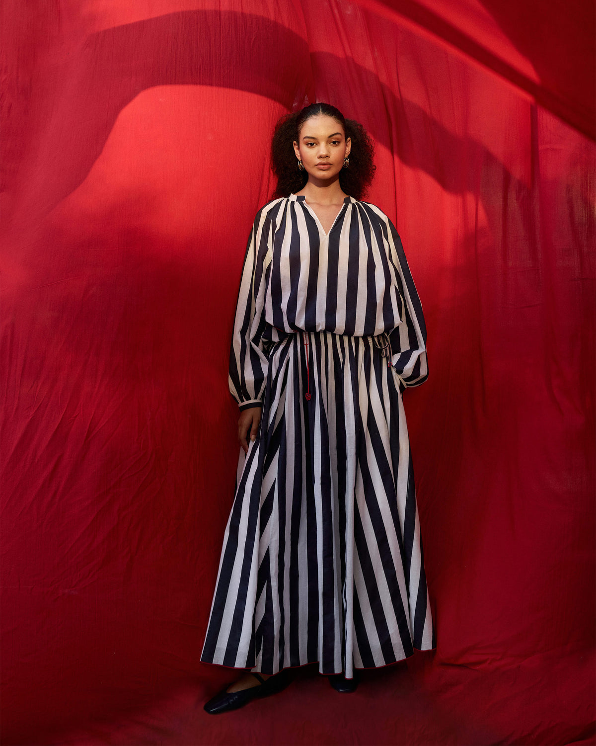 Person wearing a navy and white striped Zaya top with a V-neck.