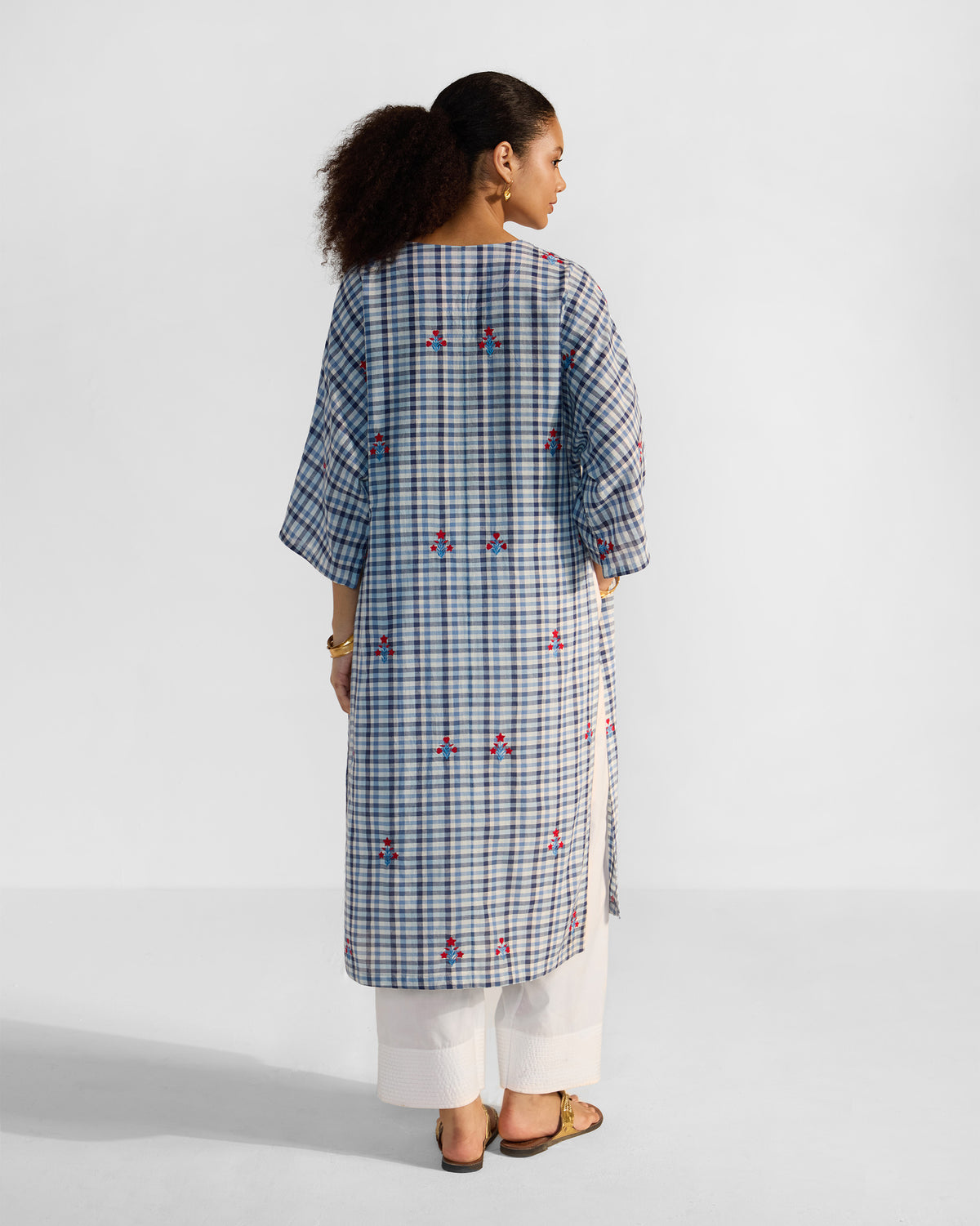 Back of a blue-and-white check Aava kurta with red embroidered motifs.