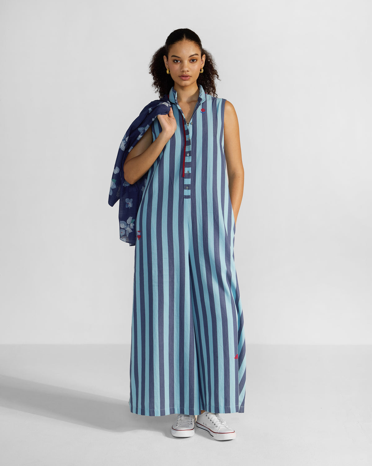 Person wearing a blue stripe Bargi jumpsuit with a stand collar.