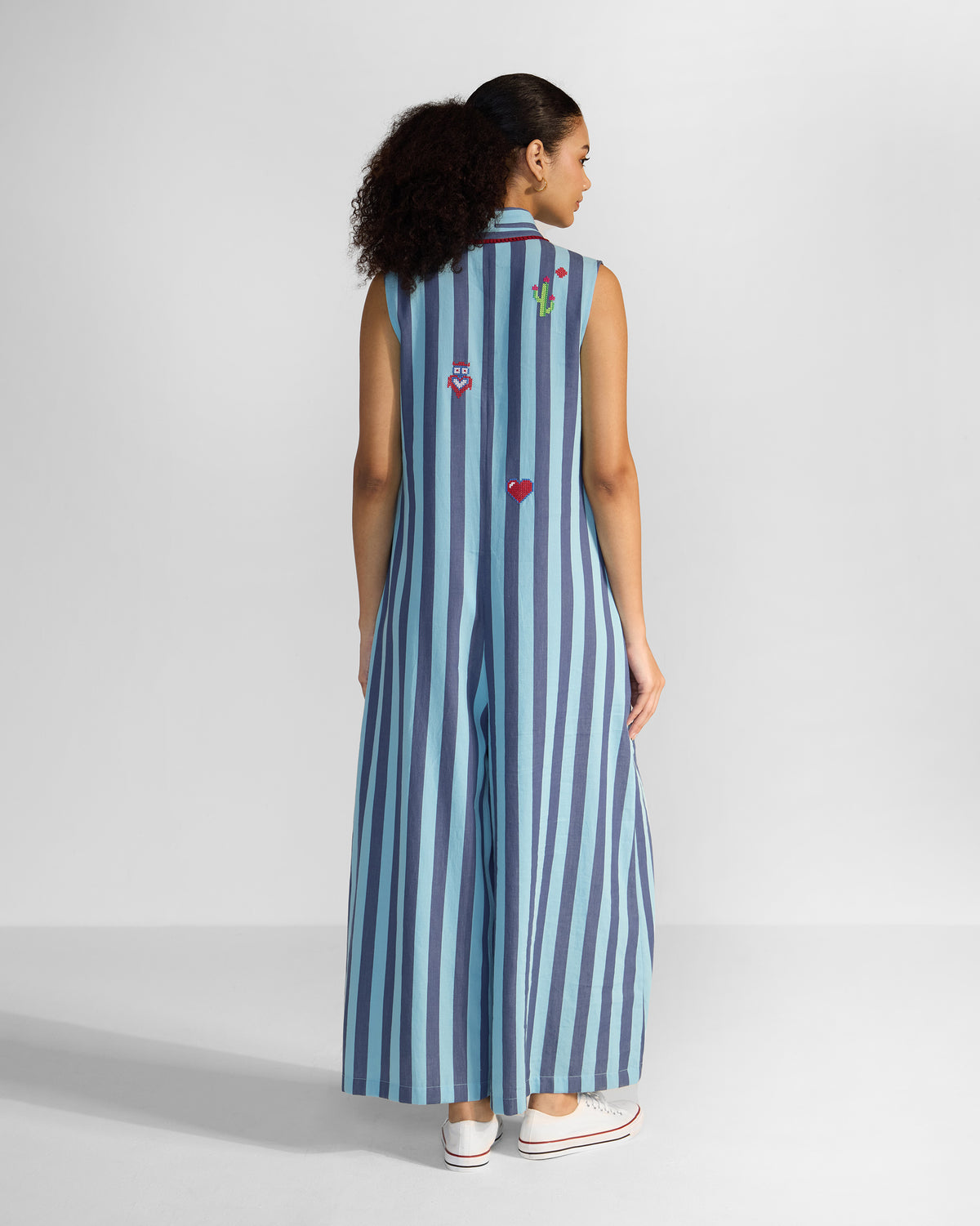 Back of a blue stripe Bargi jumpsuit with cactus and heart embroidery.