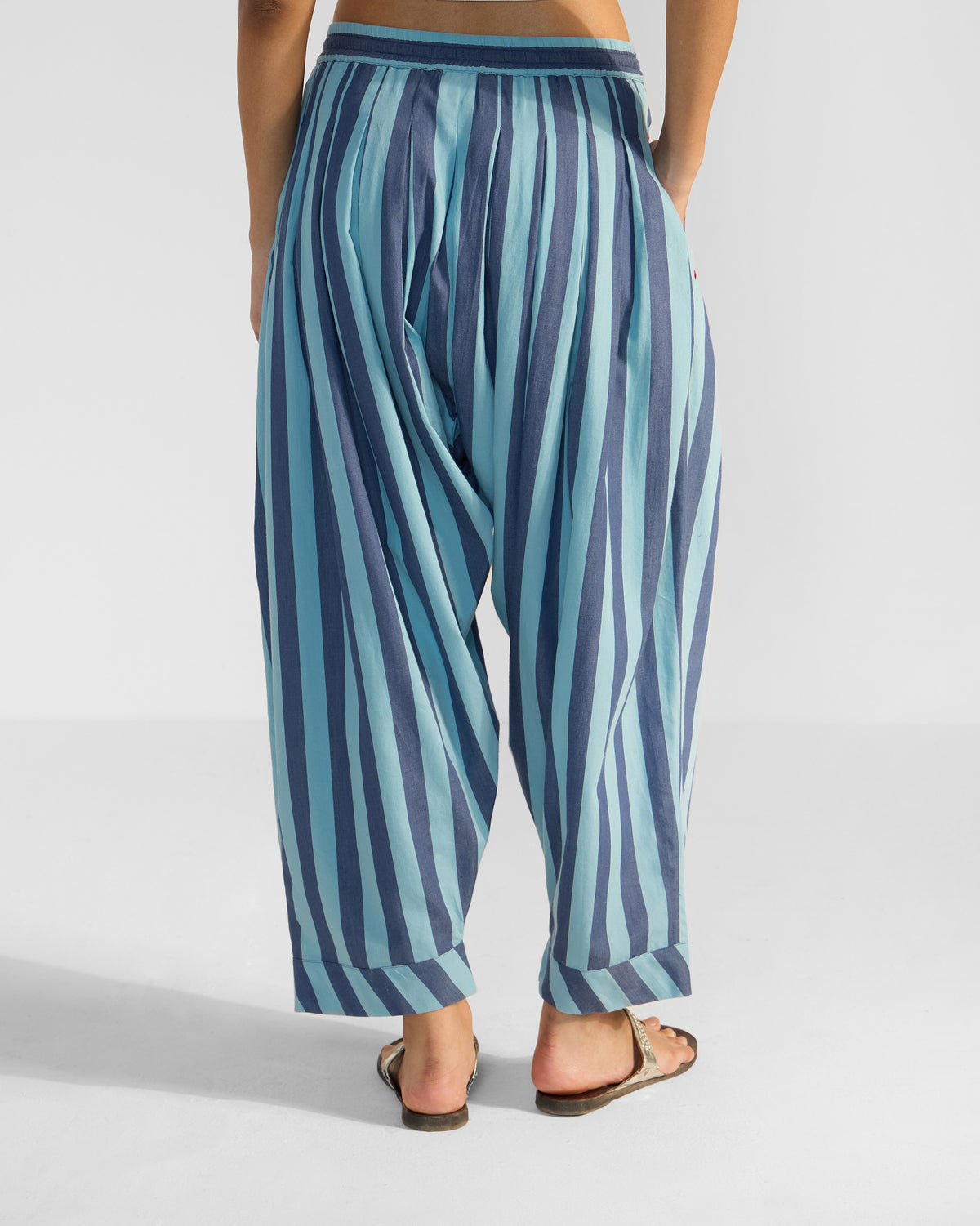 Back of blue striped salem pants with a gathered waist and cuffed ankles.