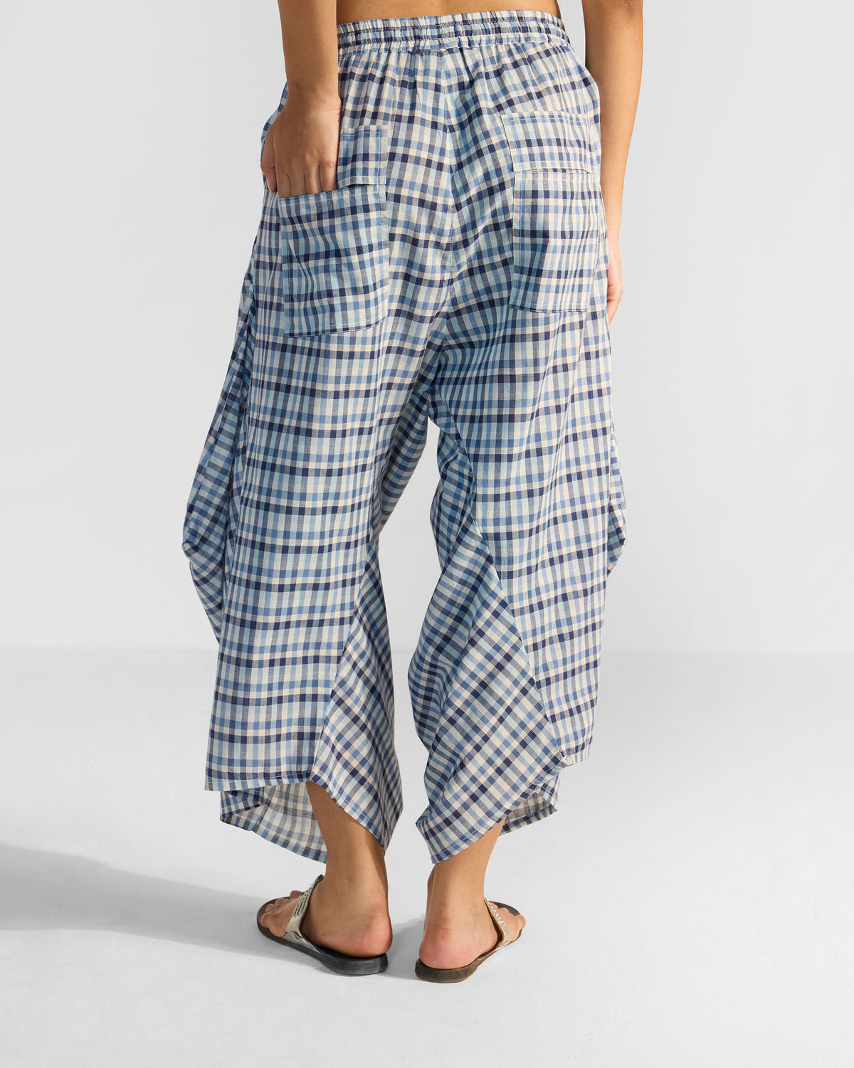 Back of blue and white checked Yoka trousers with patch pockets.