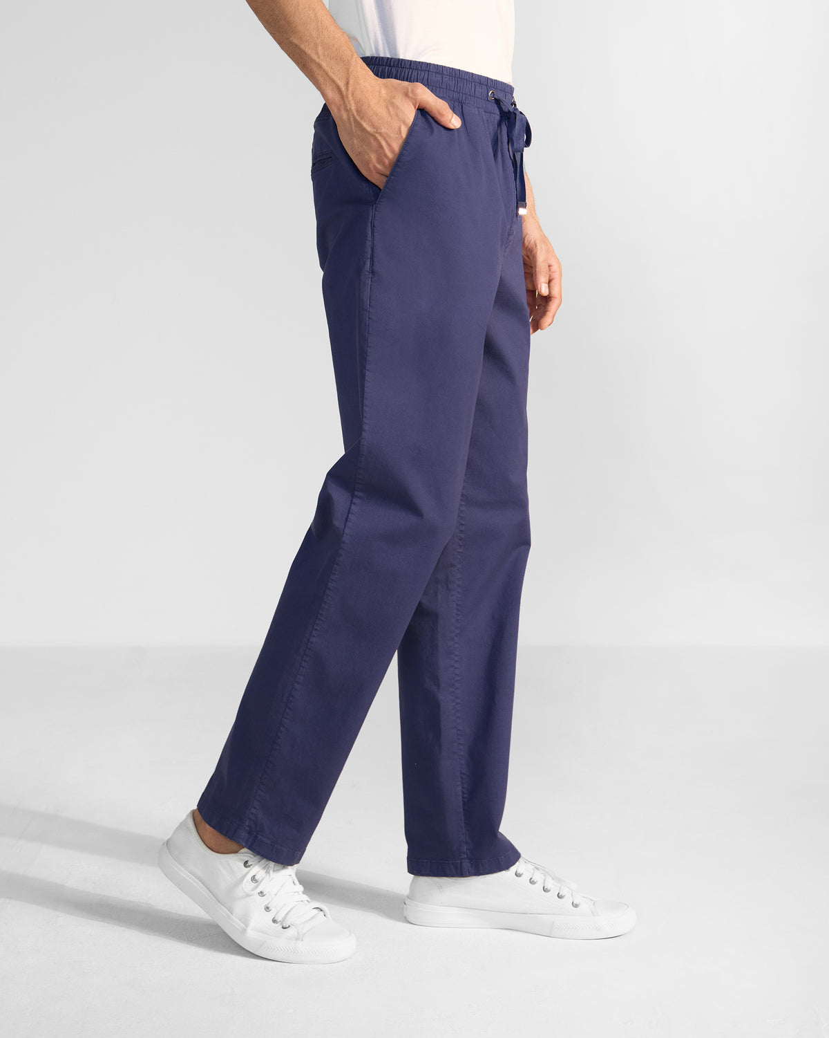 Side view of navy Pravah Trousers showing the straight leg and side pocket.