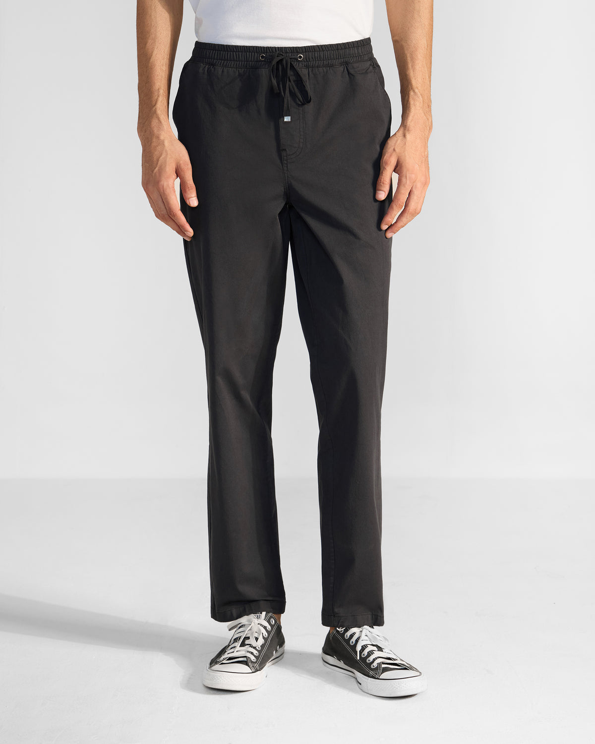 Black Pravah trousers with an elastic drawstring waist, worn front-on.