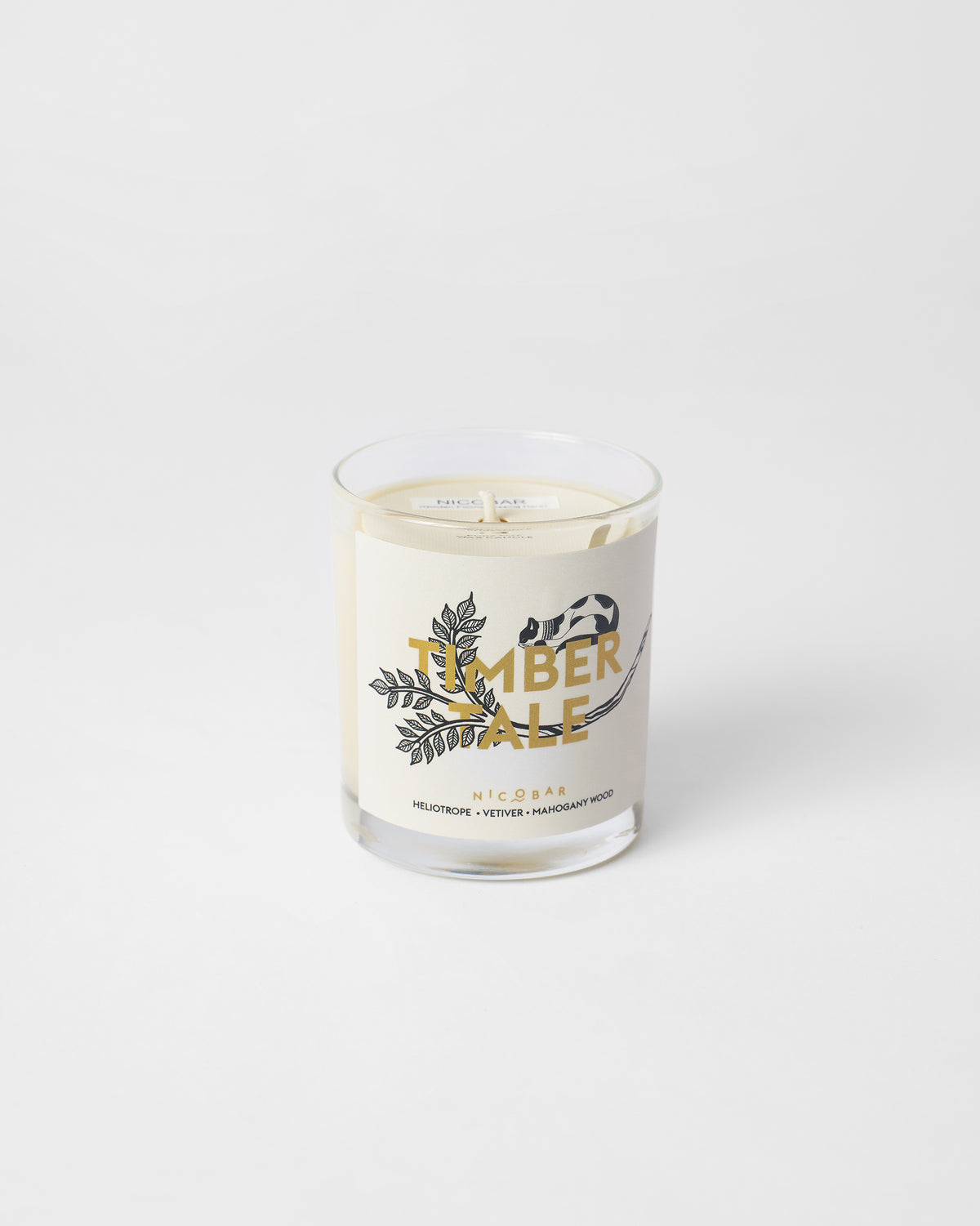 Timbertale Candle in a clear glass with a cream label and botanical sprig.