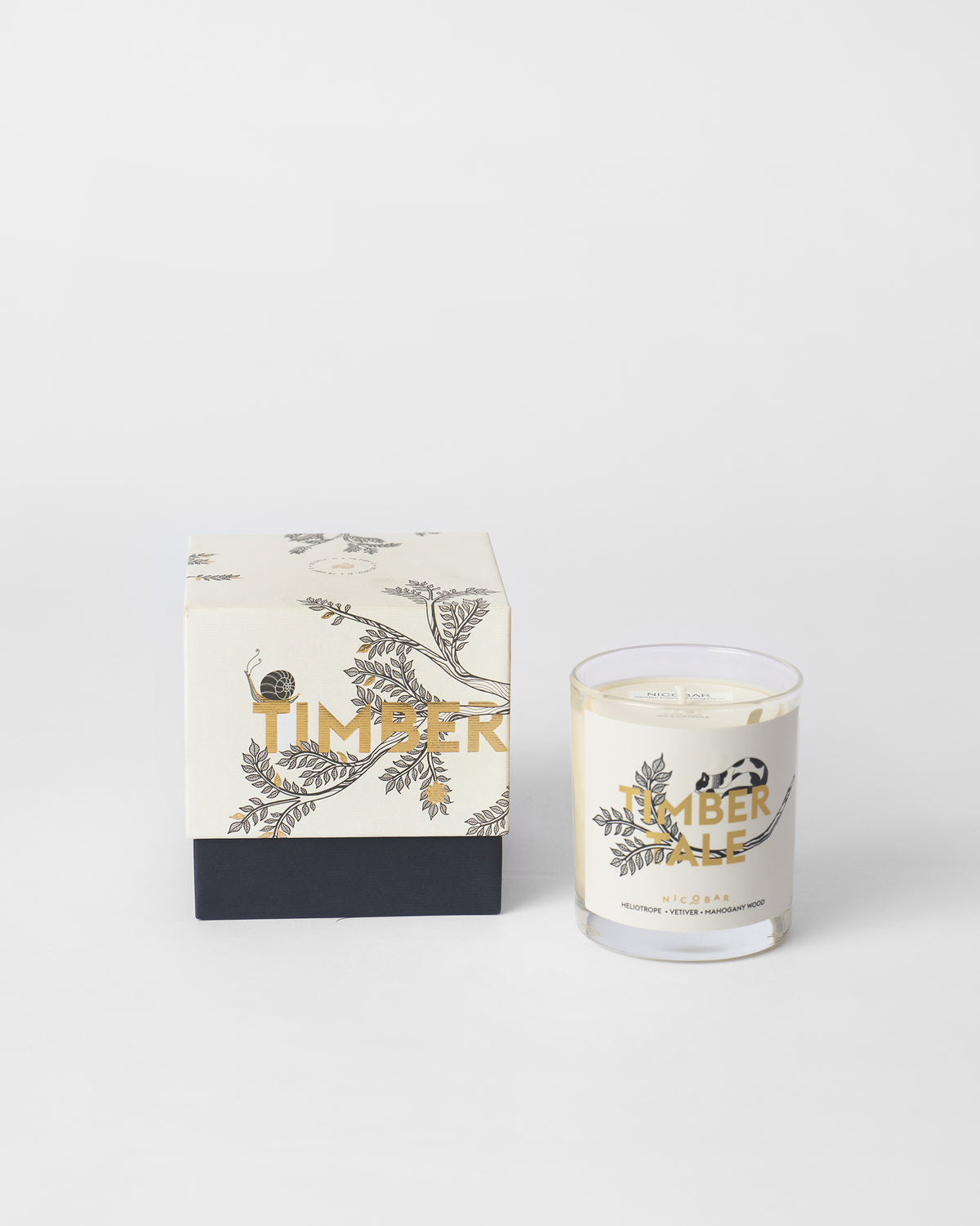 Timbertale Candle next to its gift box with a sprig design.