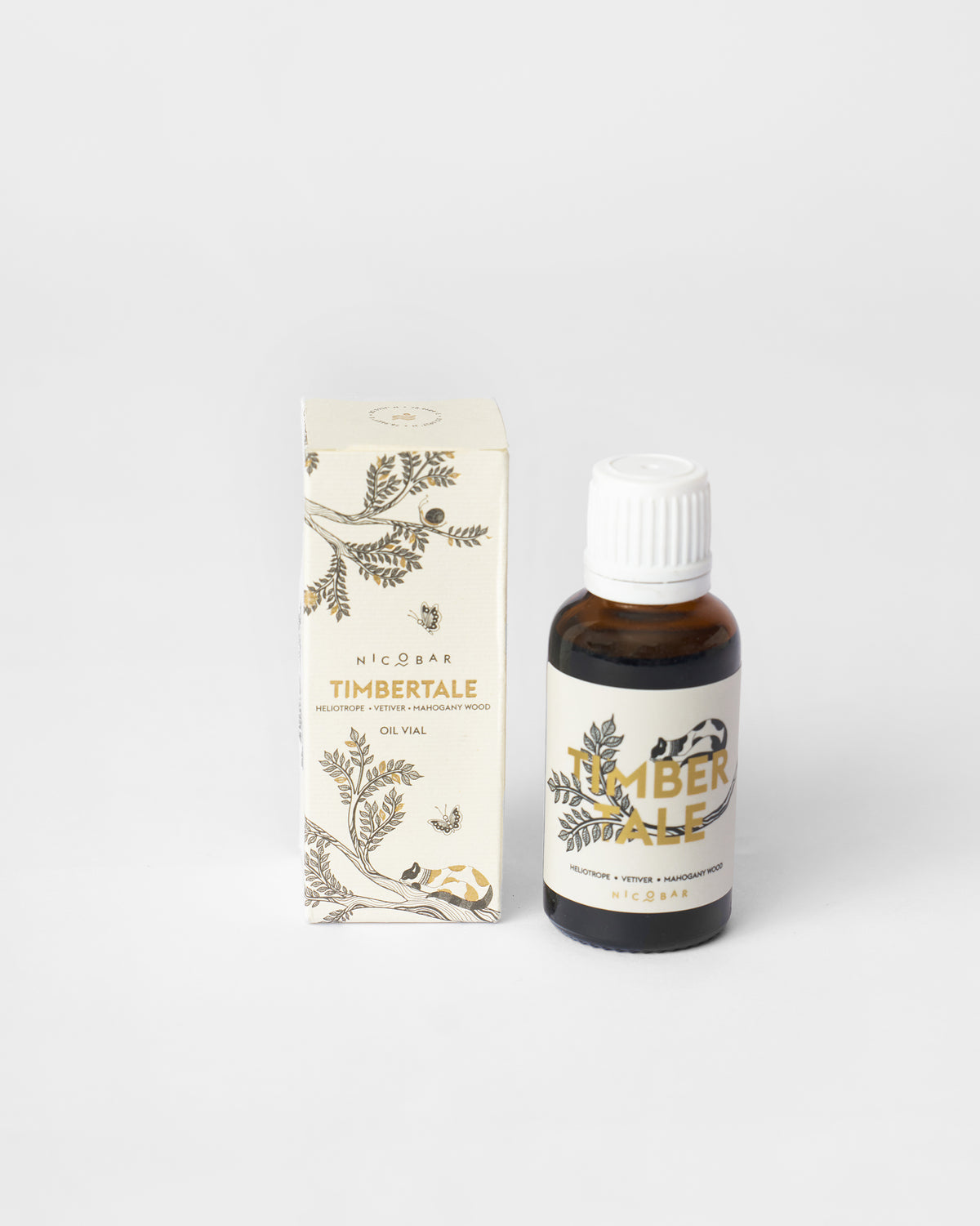 Amber Timbertale oil vial beside its cream illustrated gift box.