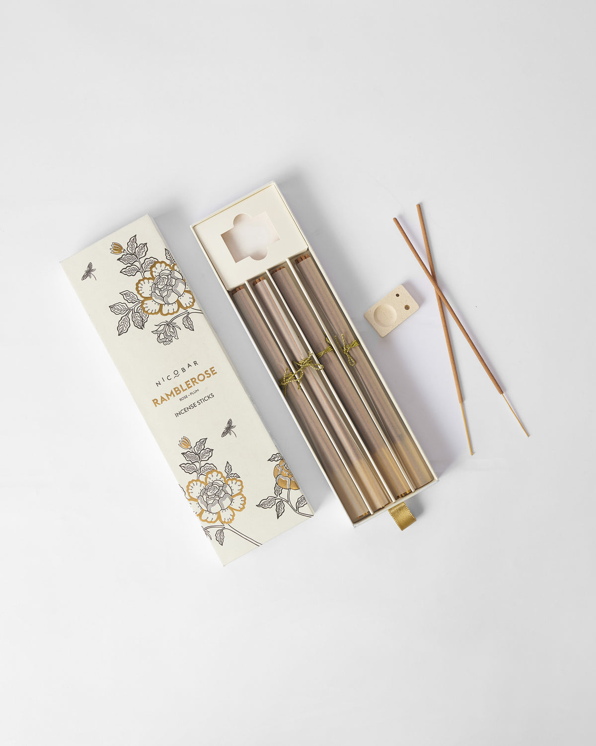 Ramblerose incense set laid flat with sticks, holder and rose box.
