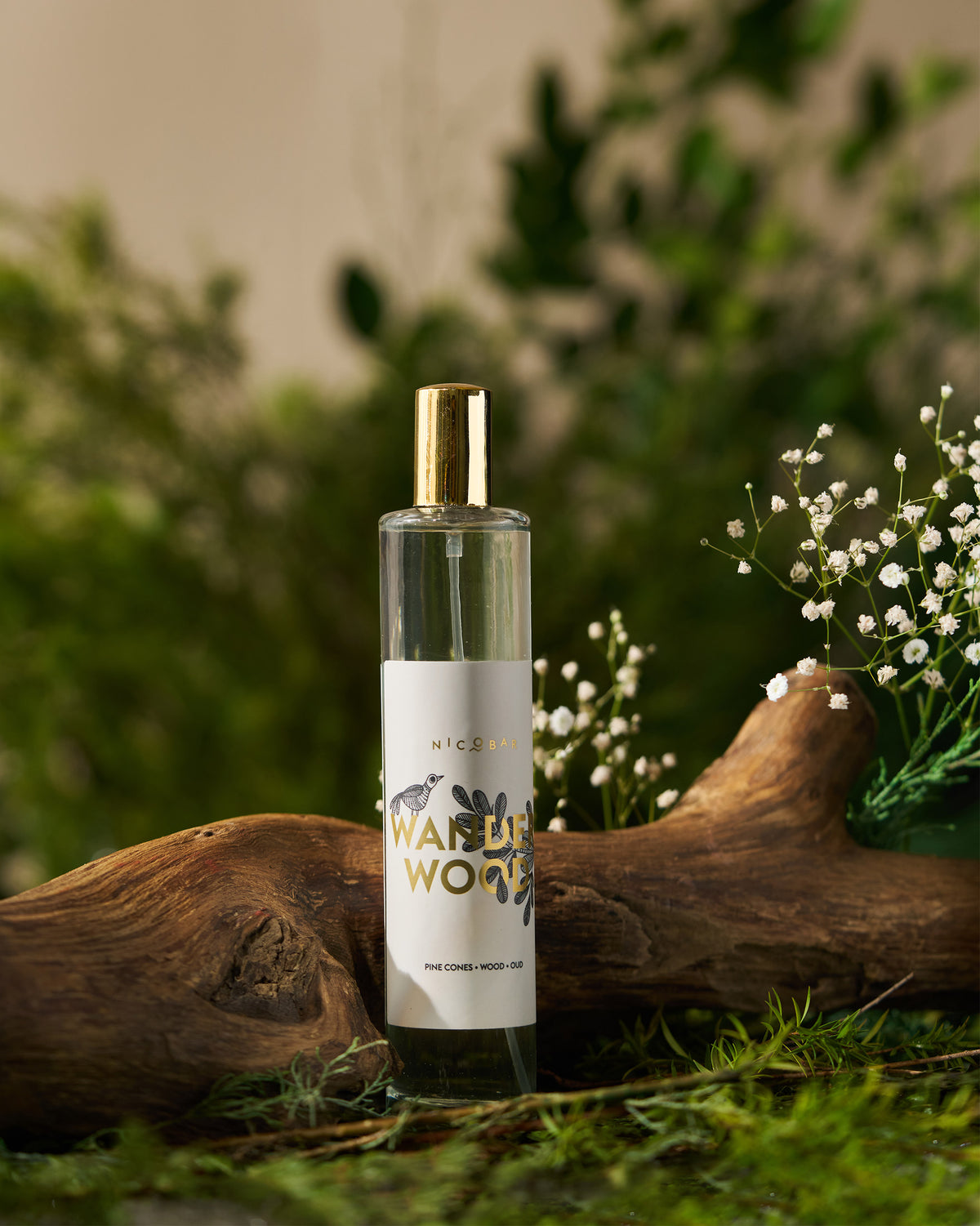 Wanderwood Room Spray in a glass bottle with a white label and gold cap.
