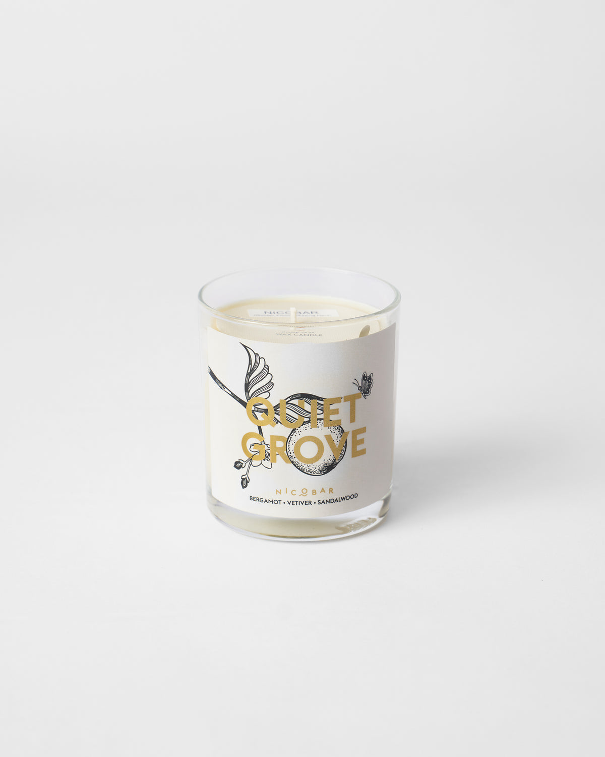 Unlit Quiet Grove Candle in a clear glass.
