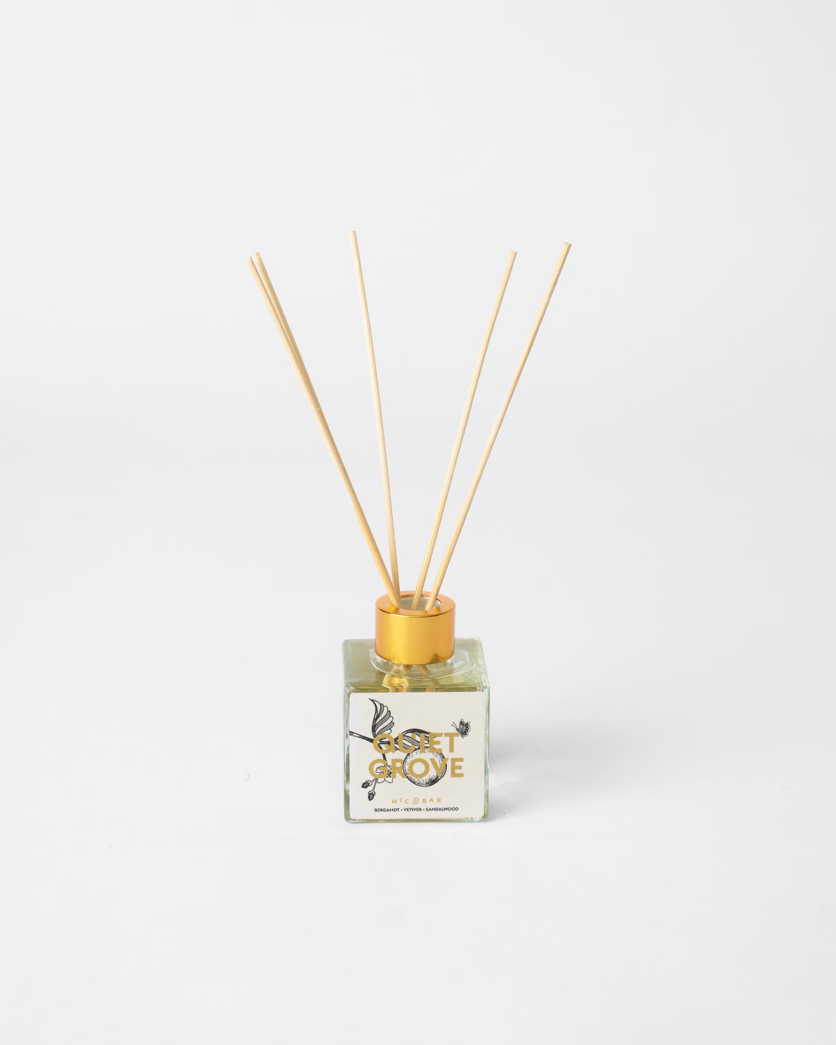 Quiet Grove reed diffuser bottle with wooden reeds and gold collar.