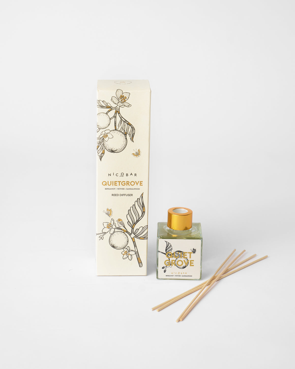 Quiet Grove reed diffuser with box, bottle, and loose wooden reeds.